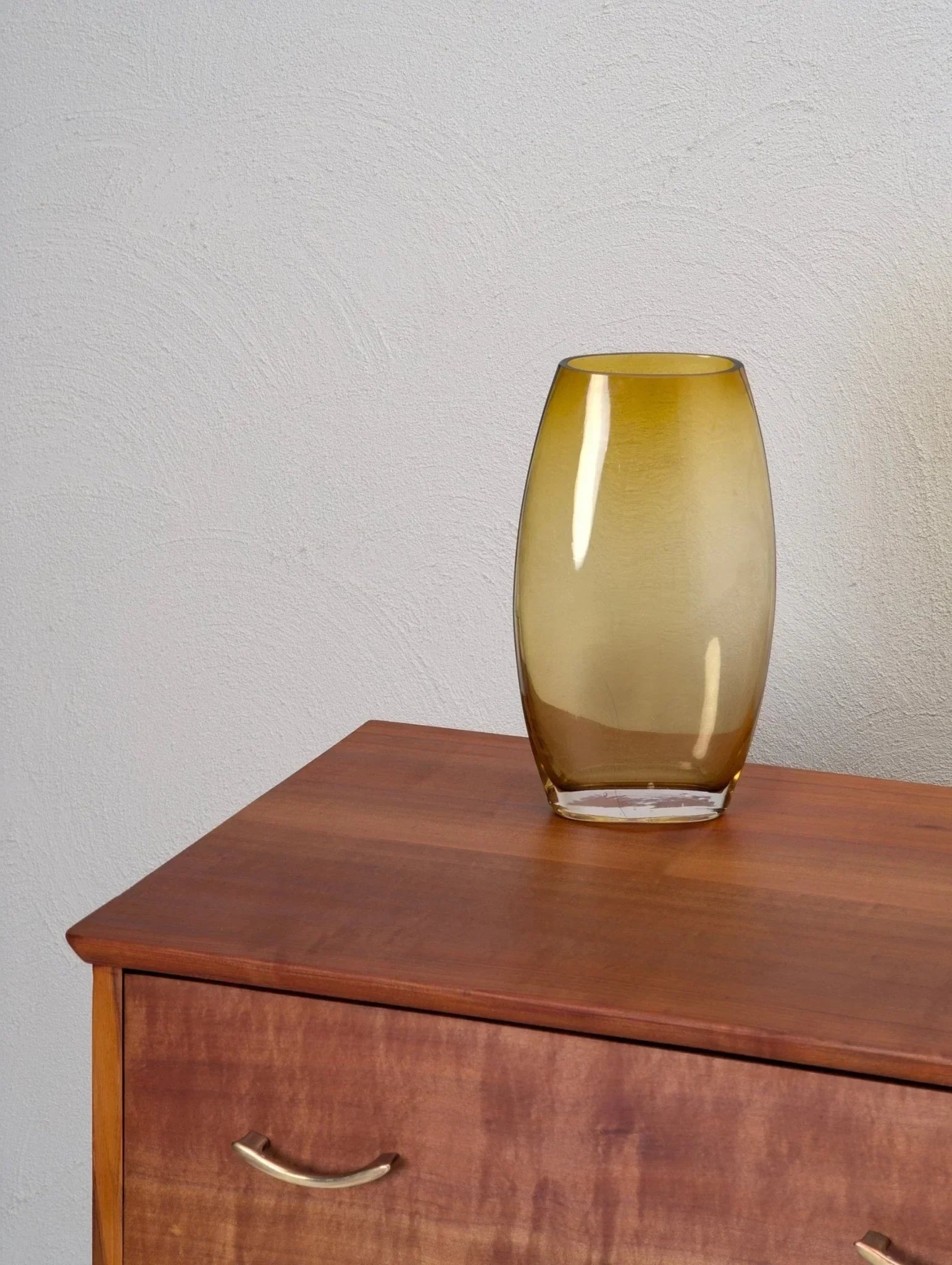 1950s Tasmanian myrtle sideboard with curved handles and amber glass vase