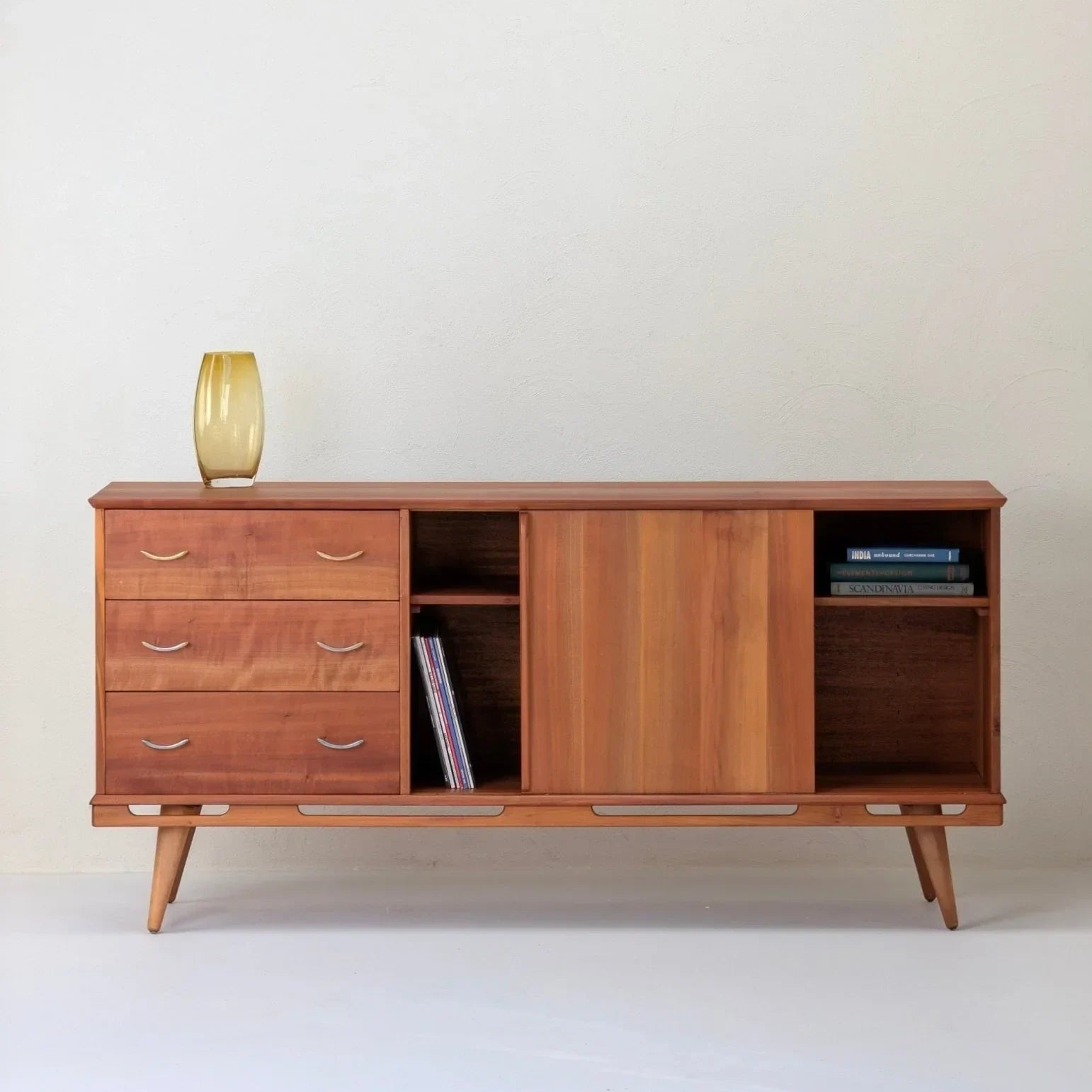 Mid-century modern Tasmanian myrtle wooden sideboard with drawers, sliding doors, and shelves with books and records