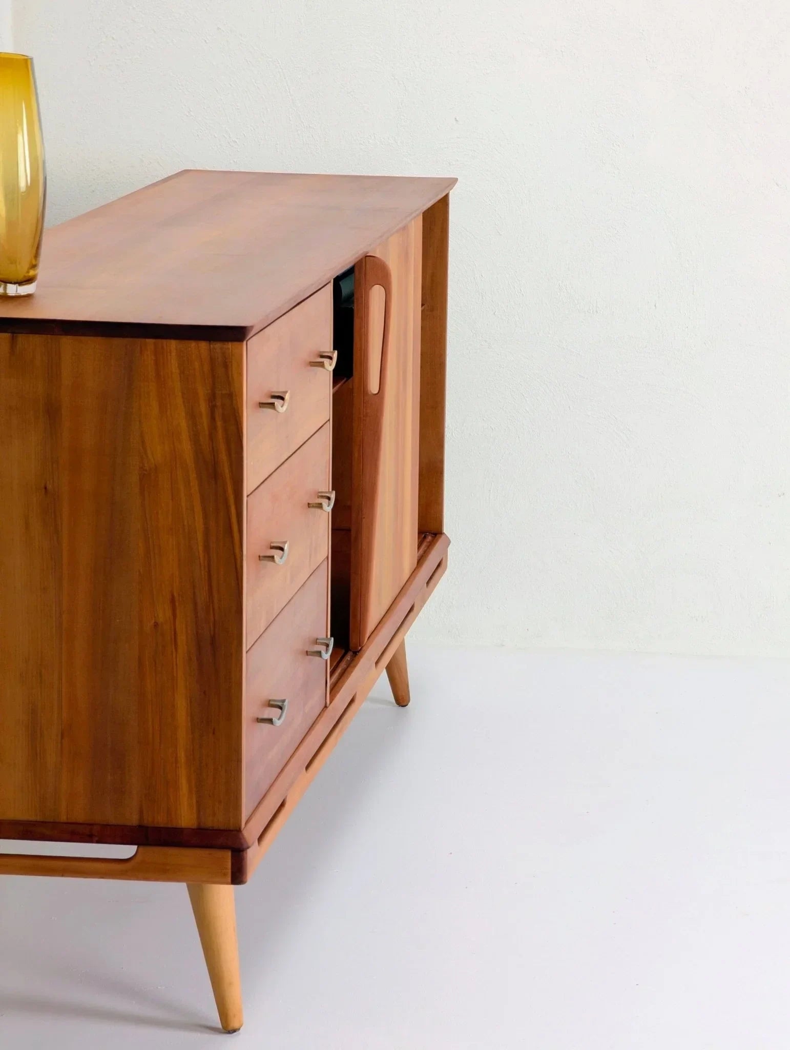 1950s Tasmanian myrtle heritage sideboard with drawers and tapered legs on white floor