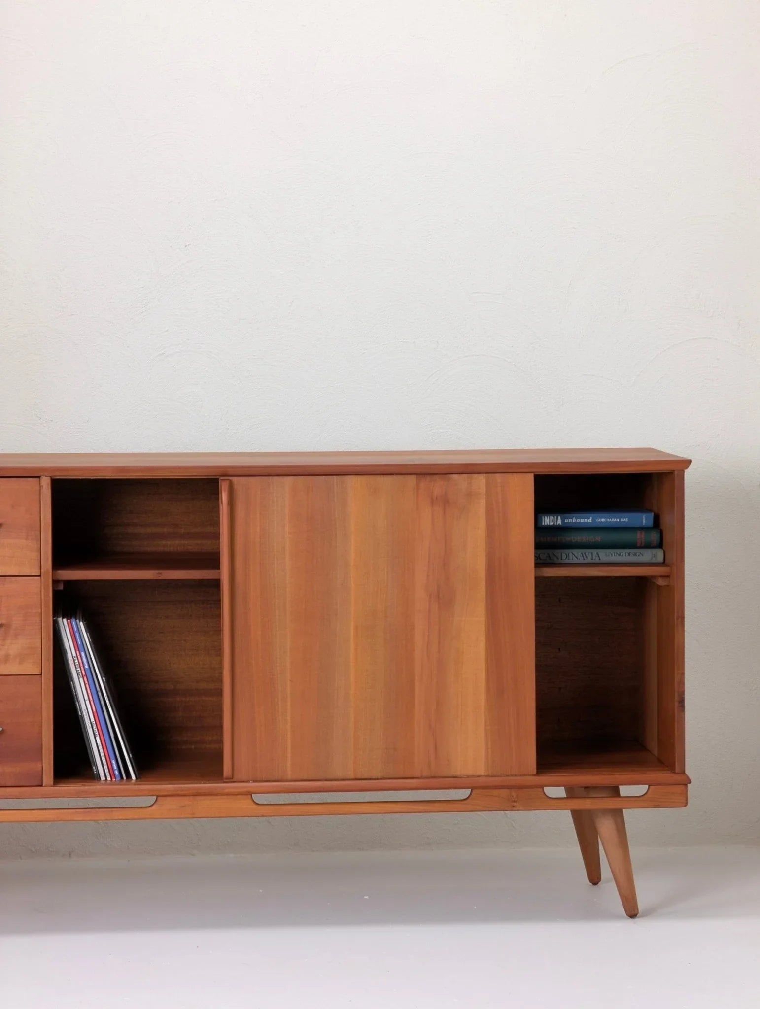 1950s Tasmanian myrtle sideboard with sliding doors, shelves, and tapered legs