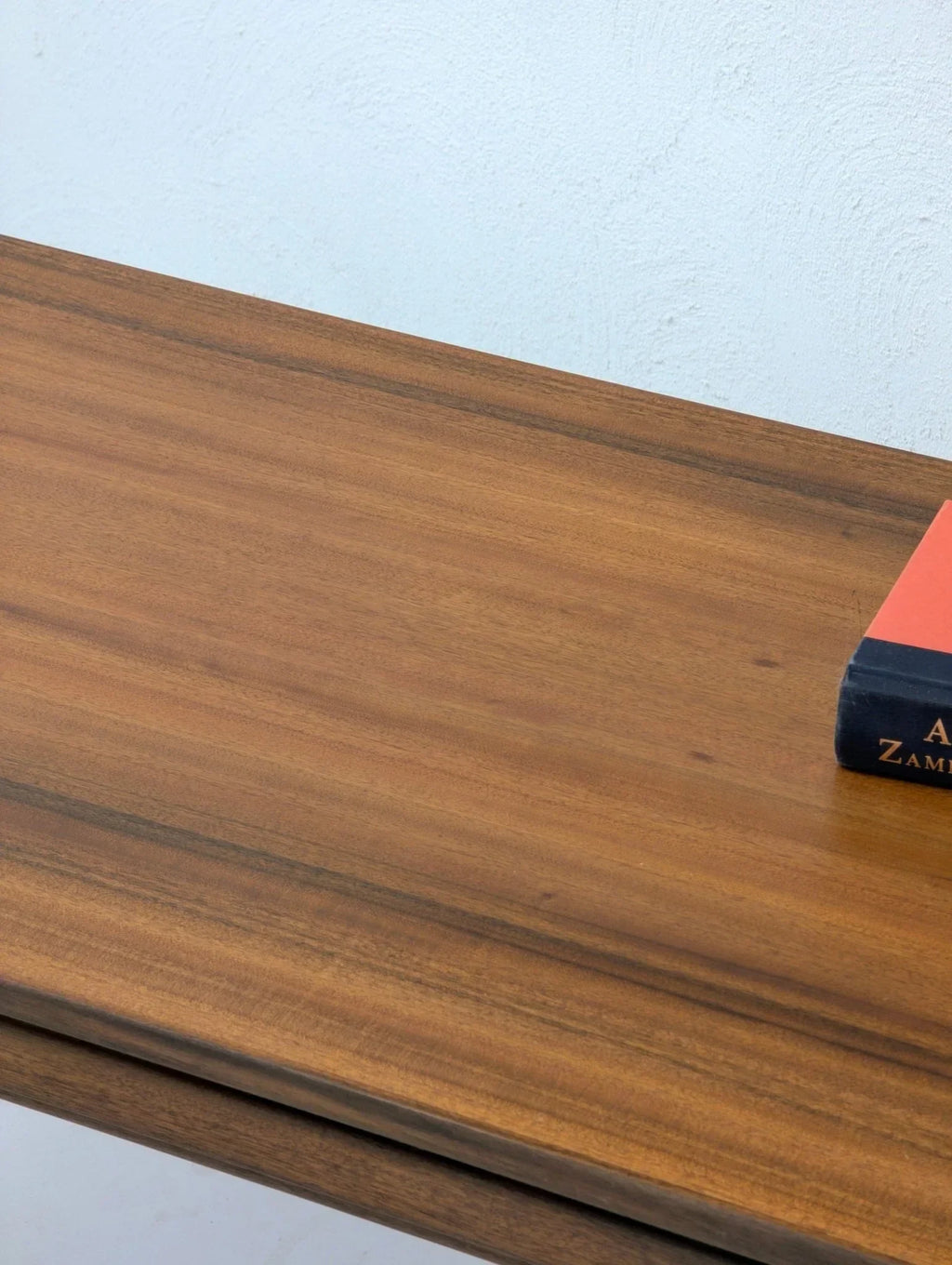 1960s mid-century Formplan coffee table with wood grain top, book on surface