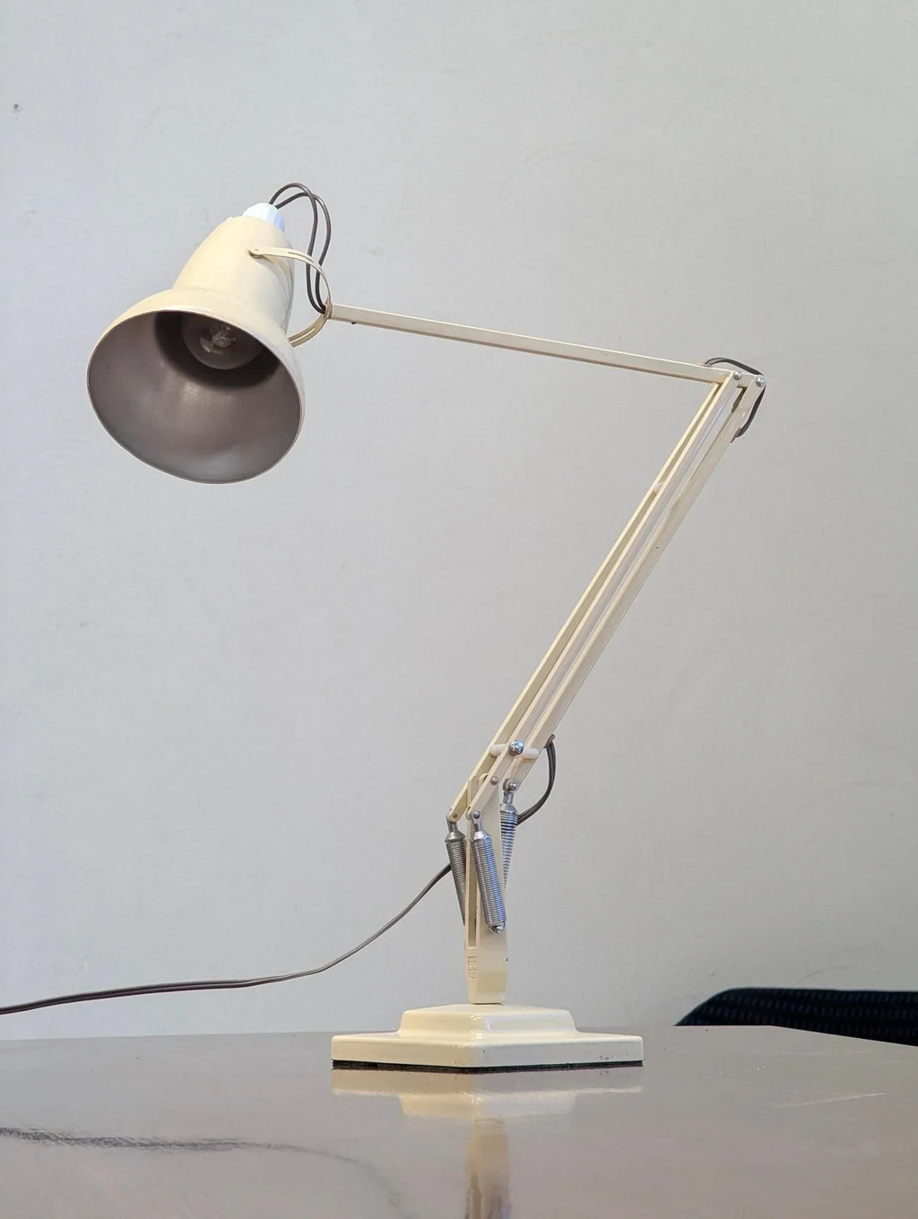 Vintage cream 1960s Herbert Terry model 1227 Anglepoise desk lamp on a table