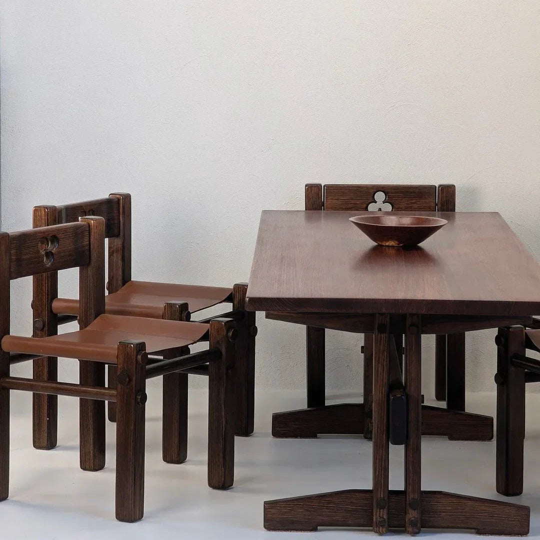 1970s dark wood alpine ash dining table with sculptural chairs and a wooden bowl