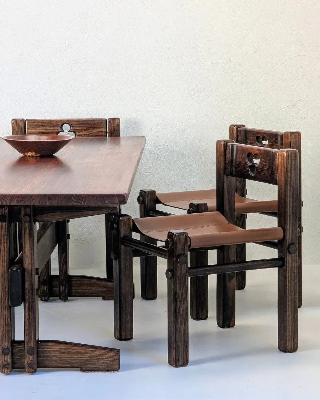1970s Alpine Ash dining table with sculptural wooden chairs in a minimalist room