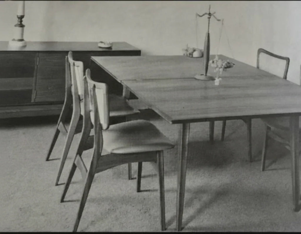 Mid-century modern dining room with wooden table, chairs, and minimalist decor
