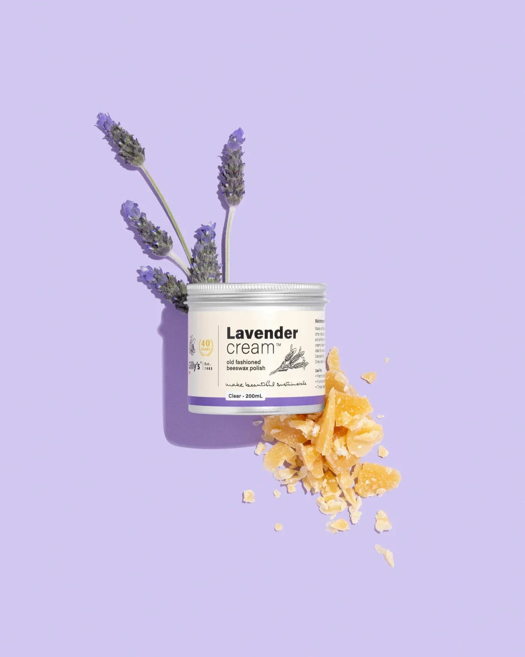 Gilly's Lavender Cream Polish 200ml jar with lavender sprigs and beeswax on purple background