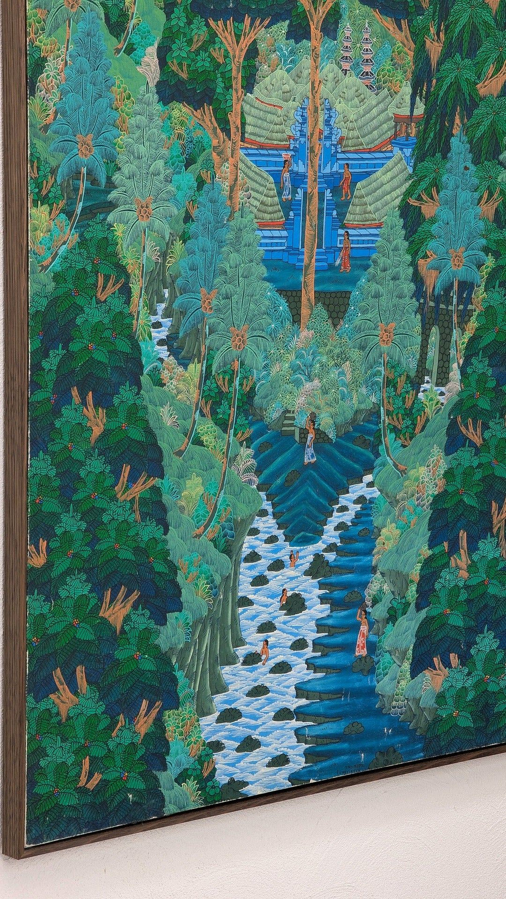Framed painting of lush tropical forest with a waterfall, flowing river, and people in traditional attire near blue temple structures