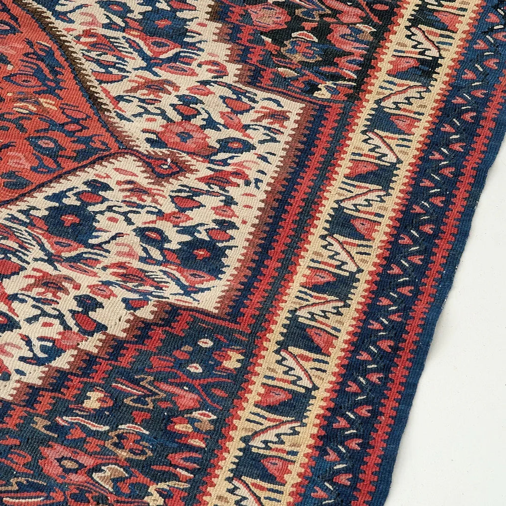 Colorful vintage Persian rug corner with intricate floral and geometric patterns