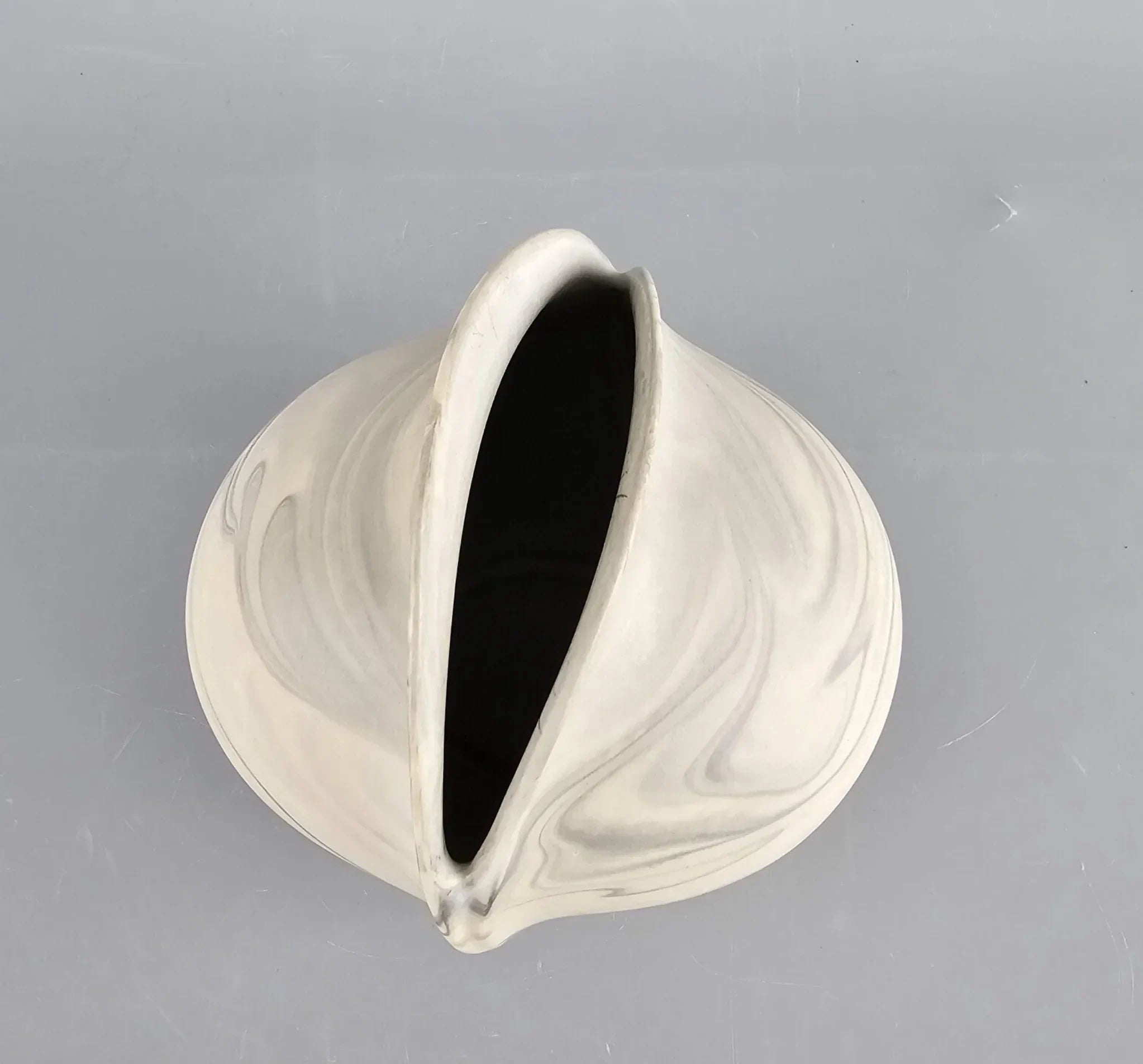 Abstract cream and gray ceramic vase with wide mouth on gray background