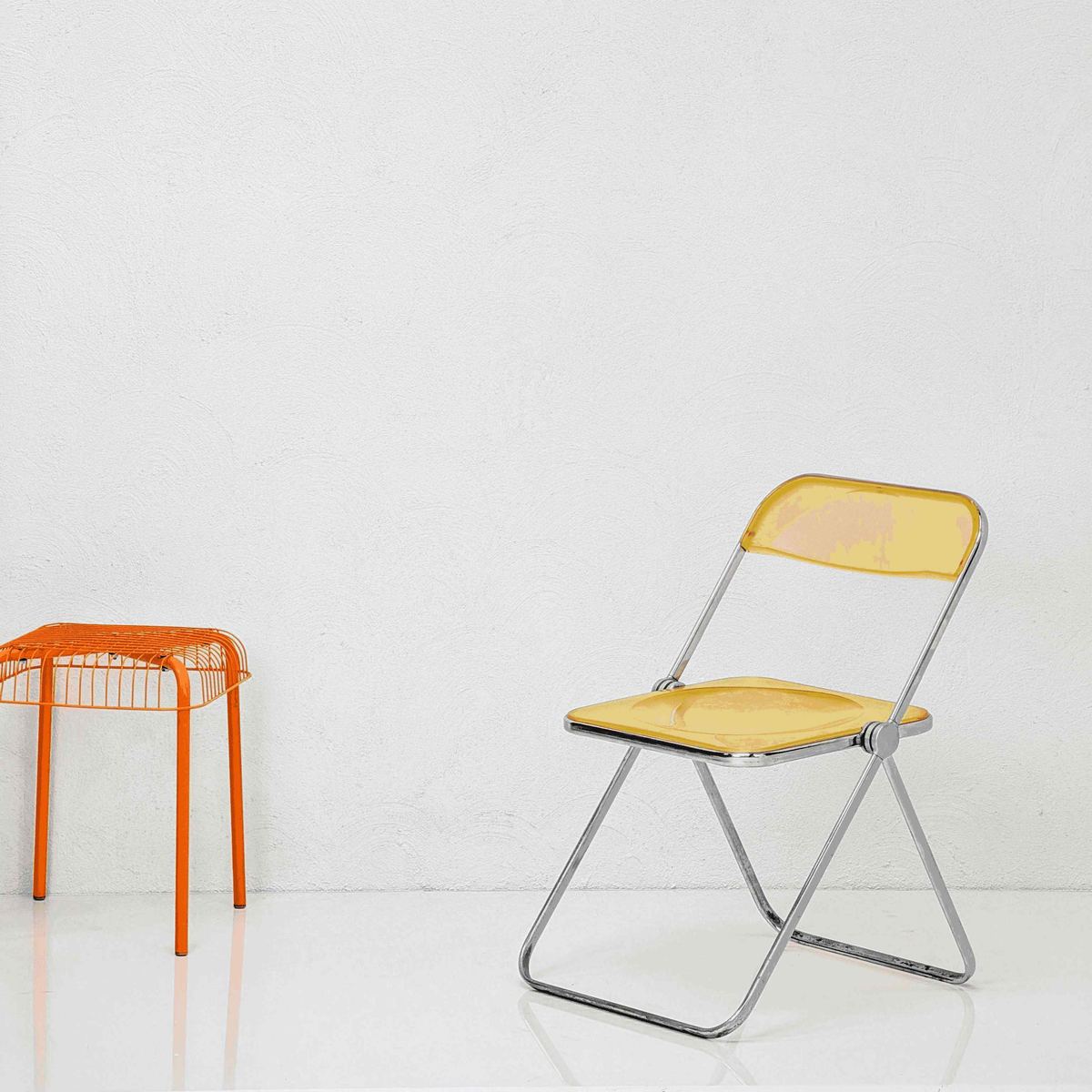 Yellow folding chair with orange metal frame on a white background

