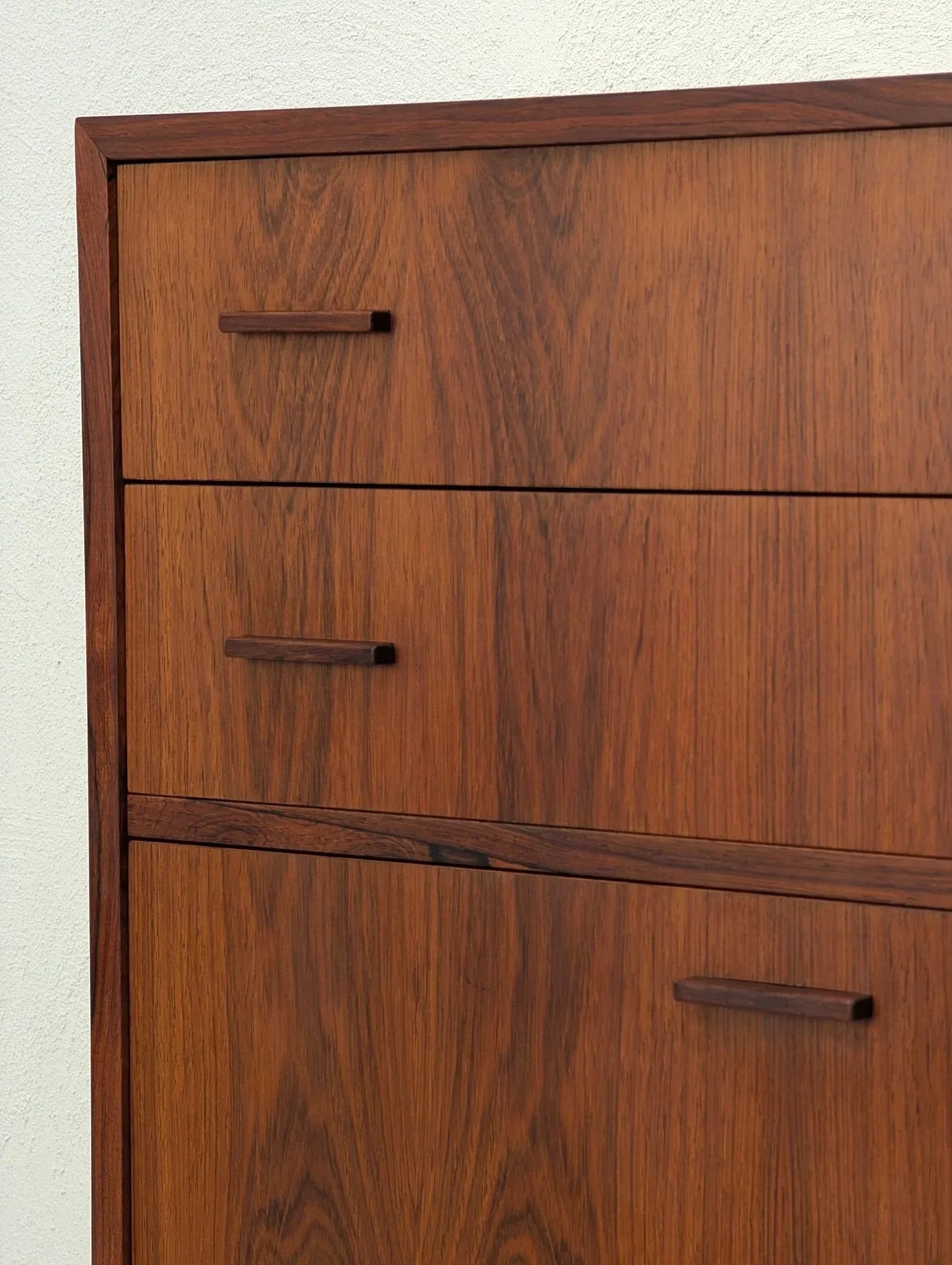 Danish modern rosewood floating cabinet with book-matched wood grain and minimalist handles