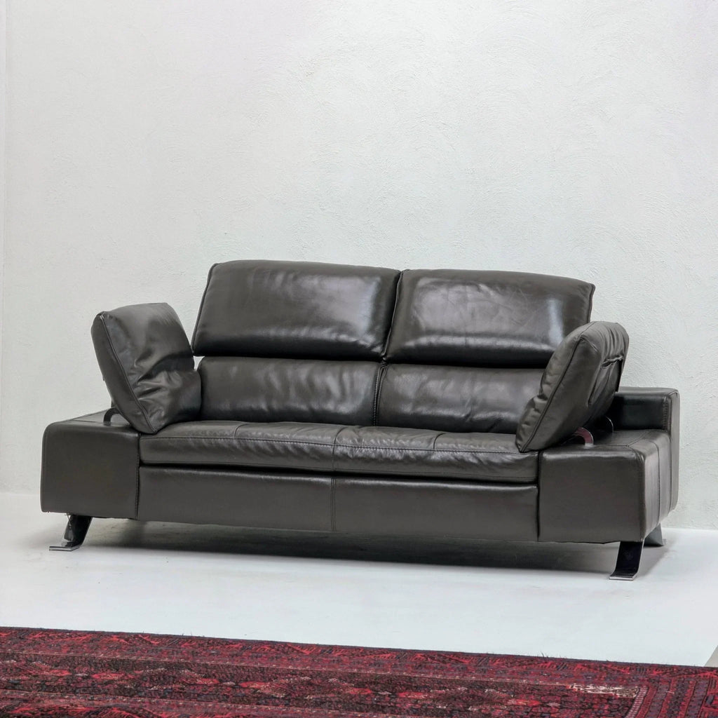 Domicil Butterfly black leather sofa with adjustable arms in modern living room setting