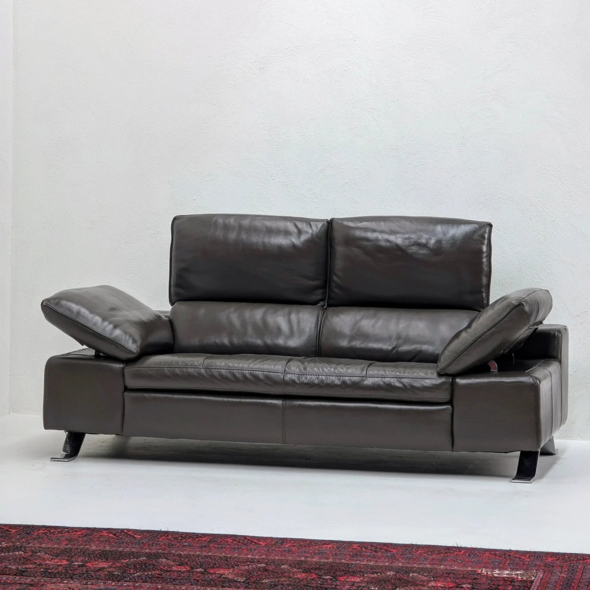 Domicil Butterfly dark brown leather sofa with adjustable arms in modern living room