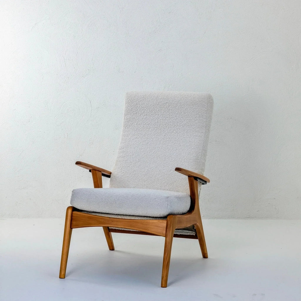 E32 armchair in creamy white boucle upholstery with wooden frame on white background