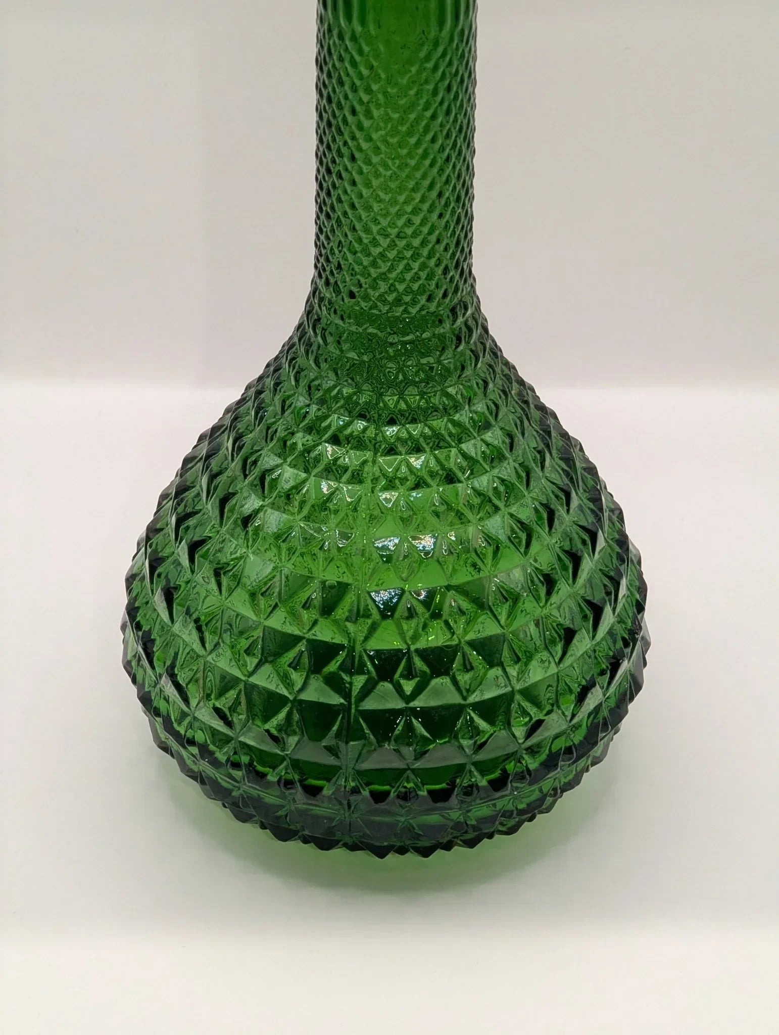 Green Empoli diamond point glass genie bottle decanter with textured pattern.