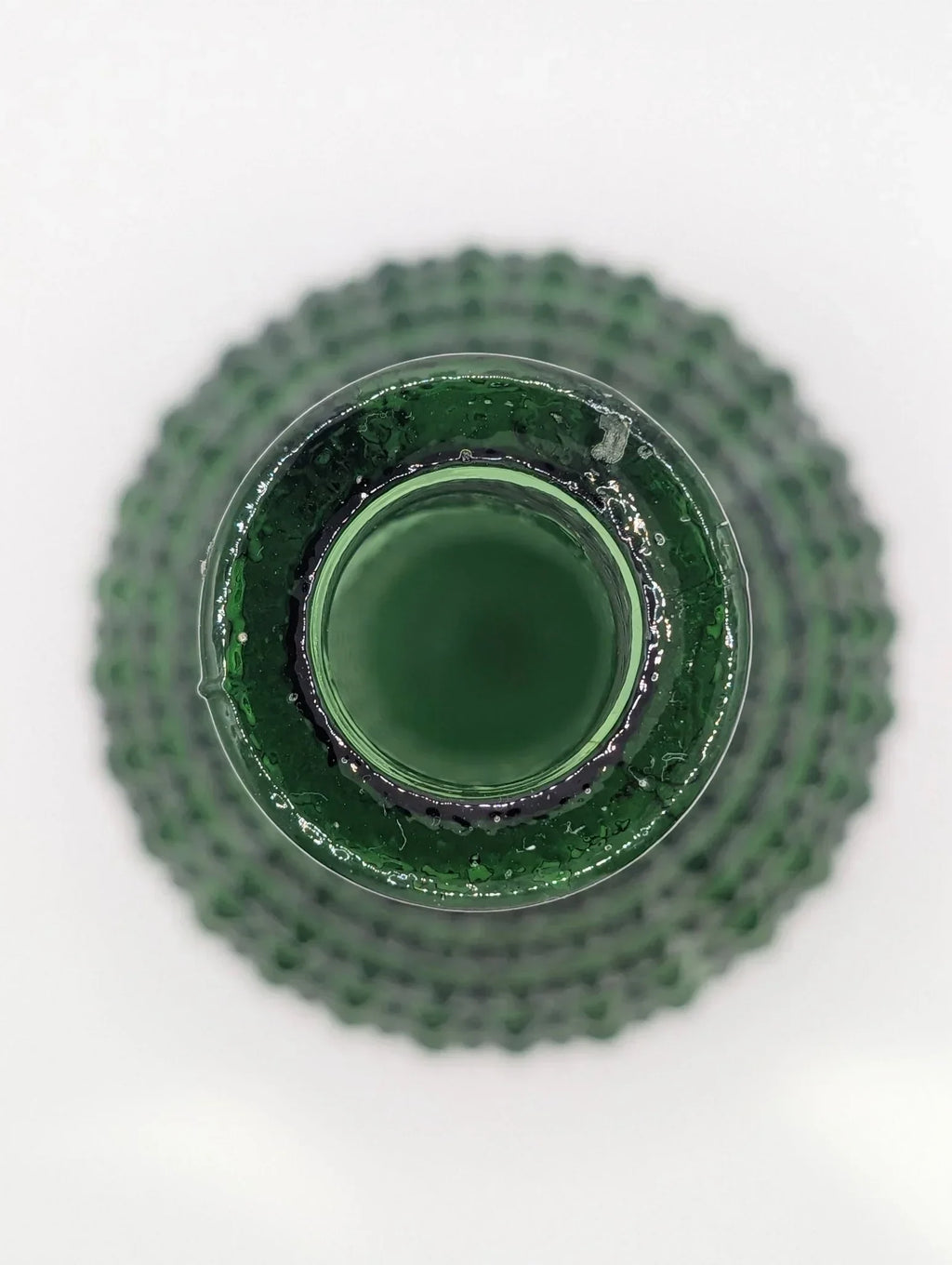 Top view of green Empoli diamond point glass decanter on white background