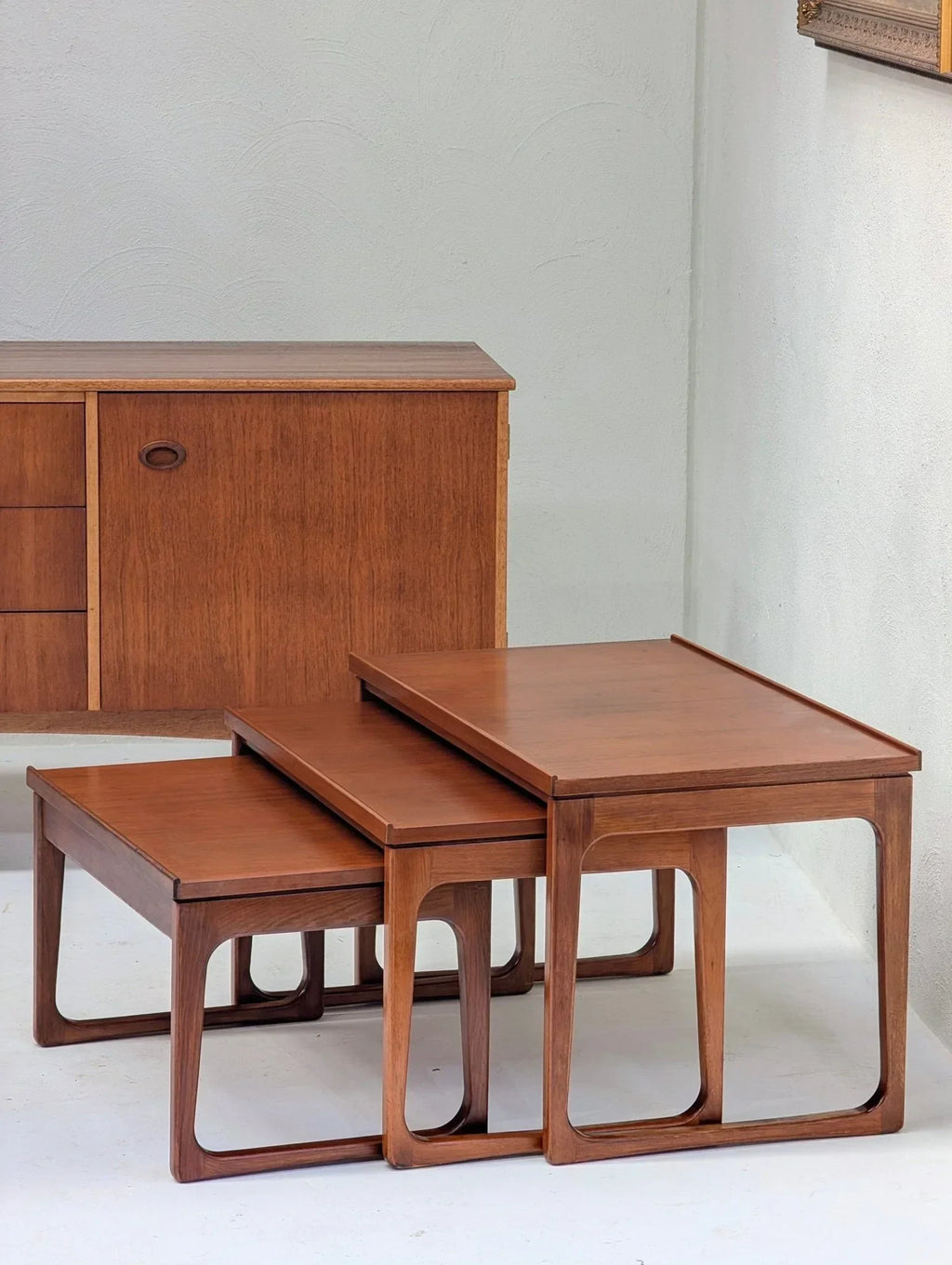Mid-century teak nesting tables by Gerald Easden, 1960s, in front of vintage sideboard