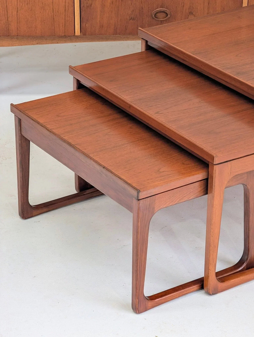 Mid-century teak nesting tables by Gerald Easden on a light floor