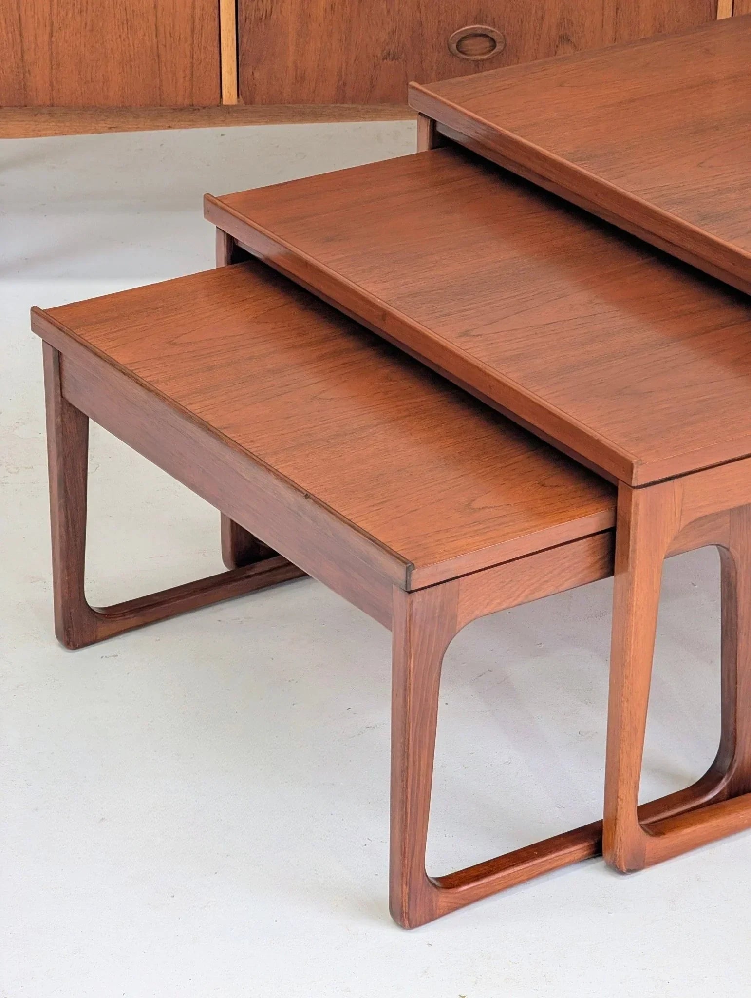 Mid-century teak nesting tables by Gerald Easden on a light floor