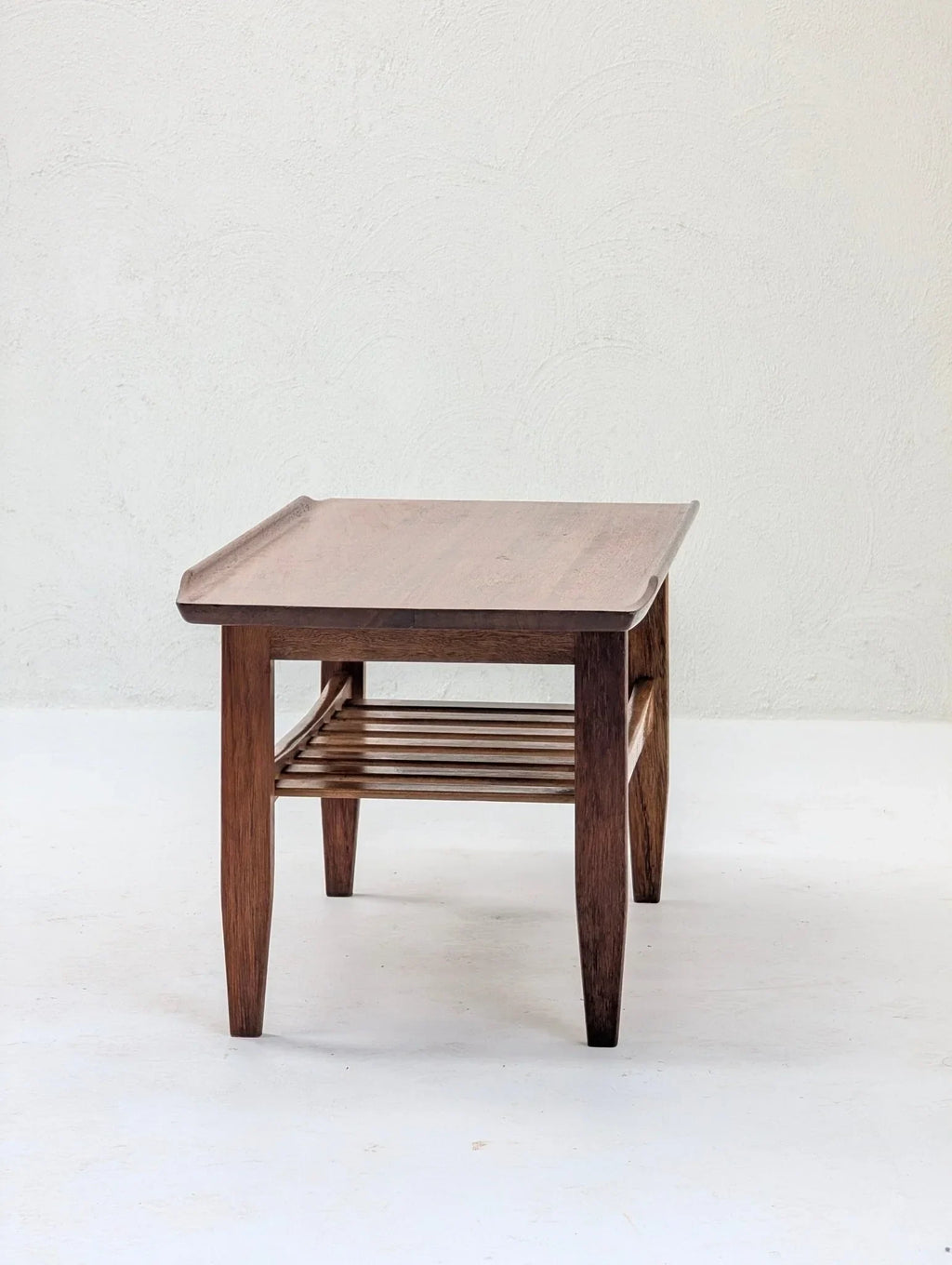 Italian solid teak tray top coffee table with slatted shelf, mid-century design, on white background