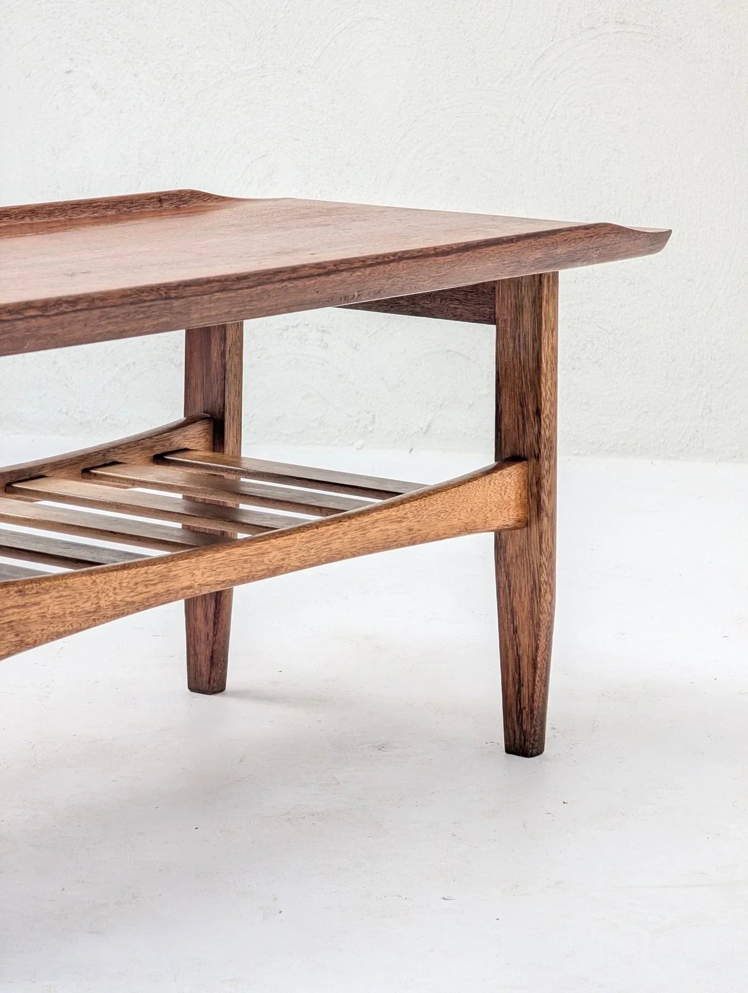 Italian solid teak tray top coffee table with slatted shelf on white background