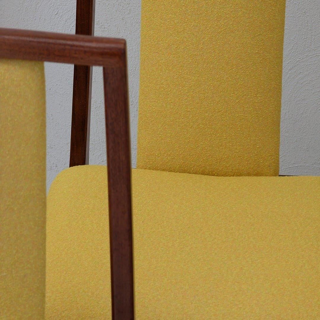 Mid-century modern dining chairs with yellow upholstery and wooden frames