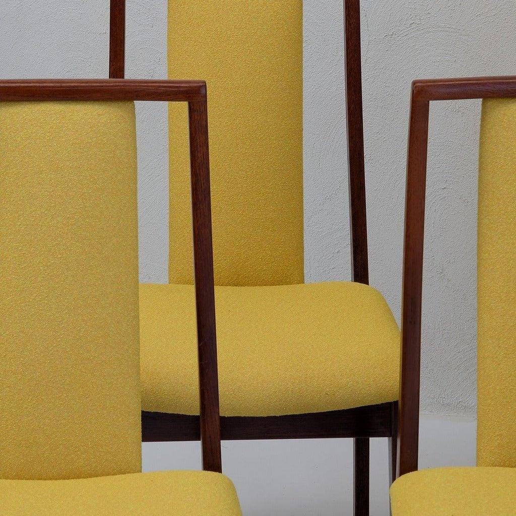 Mid-century modern dining chairs with yellow upholstery and wooden frames