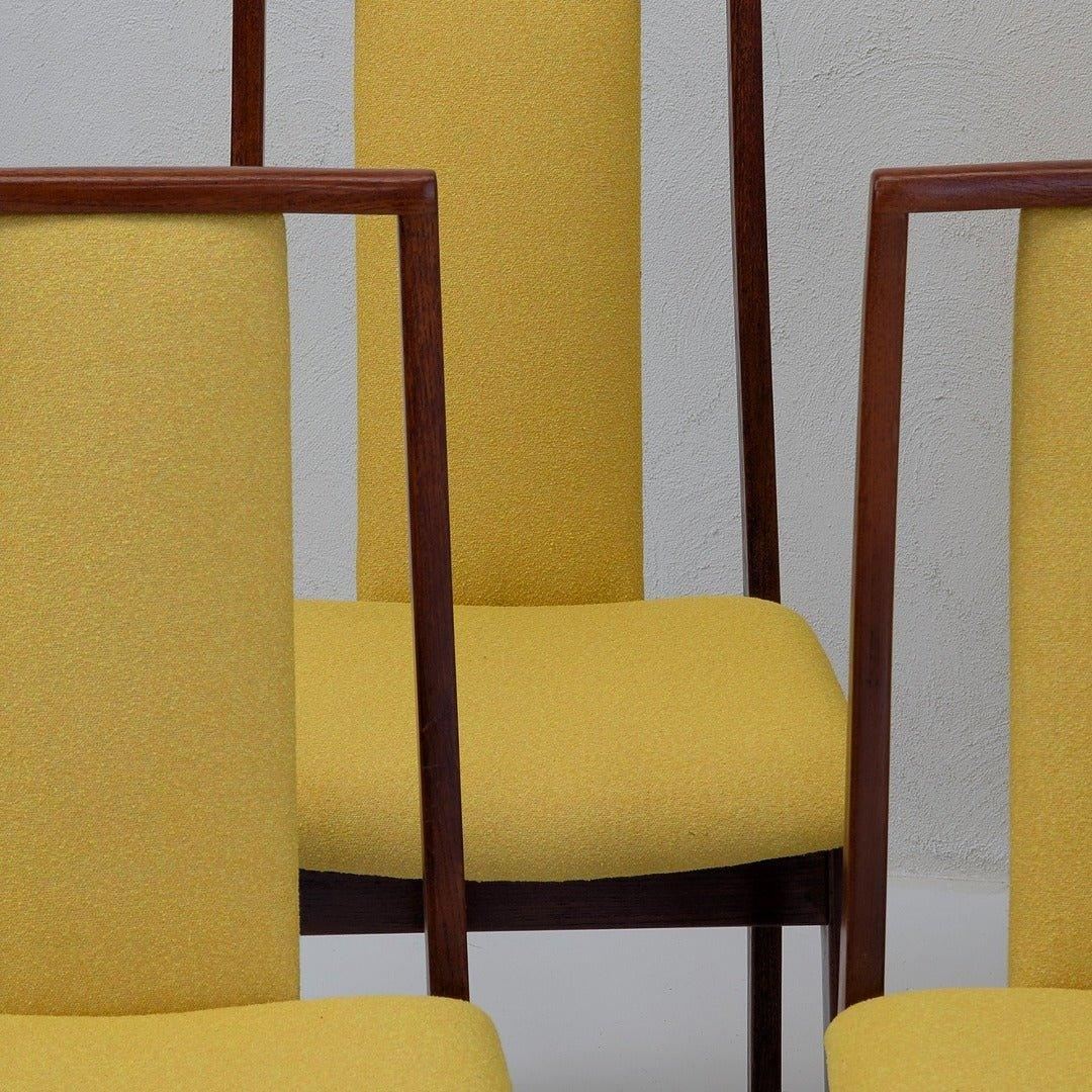 Mid-century modern dining chairs with yellow upholstery and wooden frames