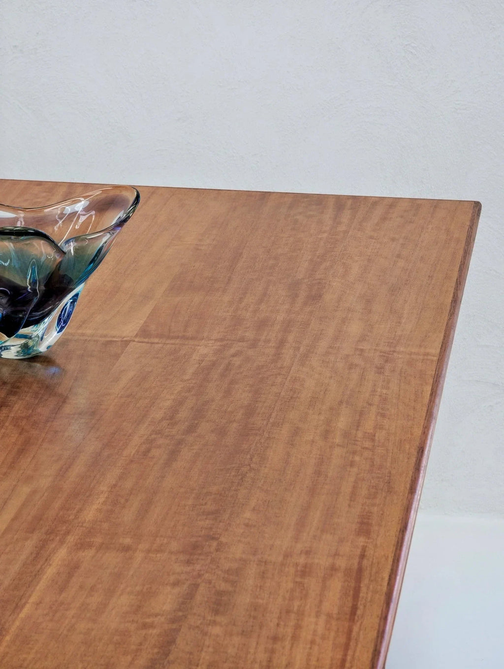 Mid-century modern golden teak dining table with glass centerpiece