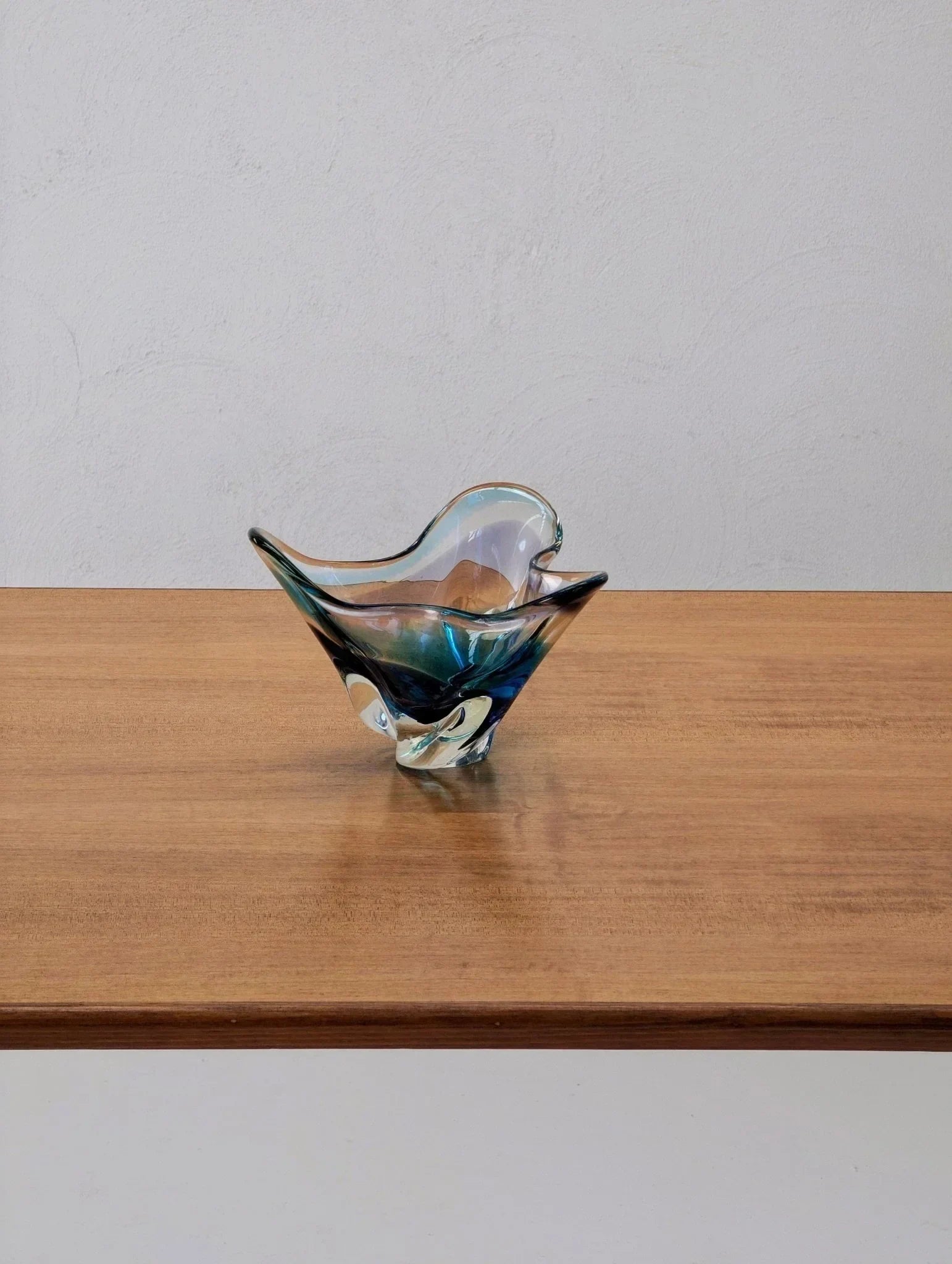 Mid-century modern golden teak dining table with decorative glass bowl