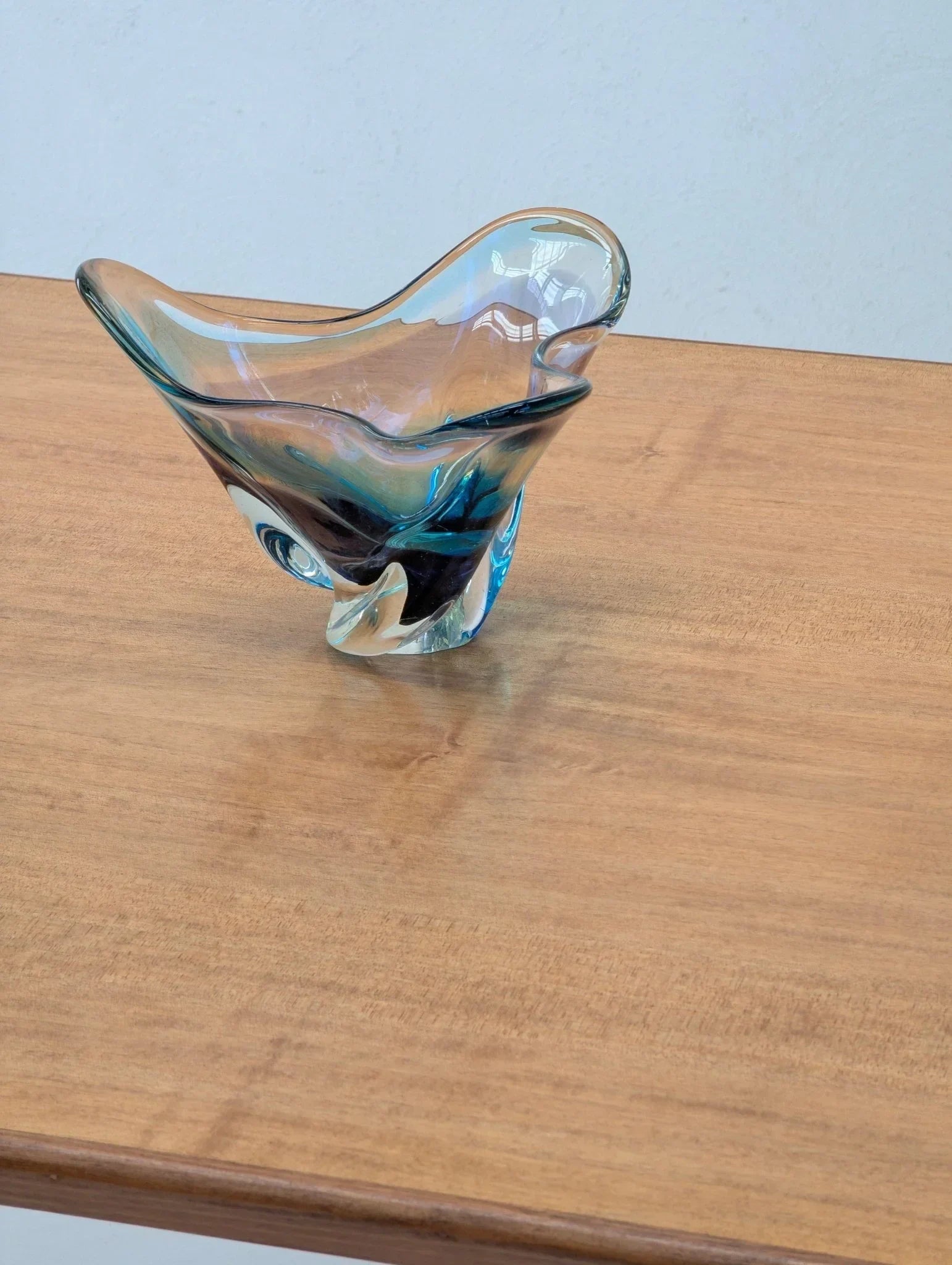 Mid-century modern golden teak dining table with blue glass bowl