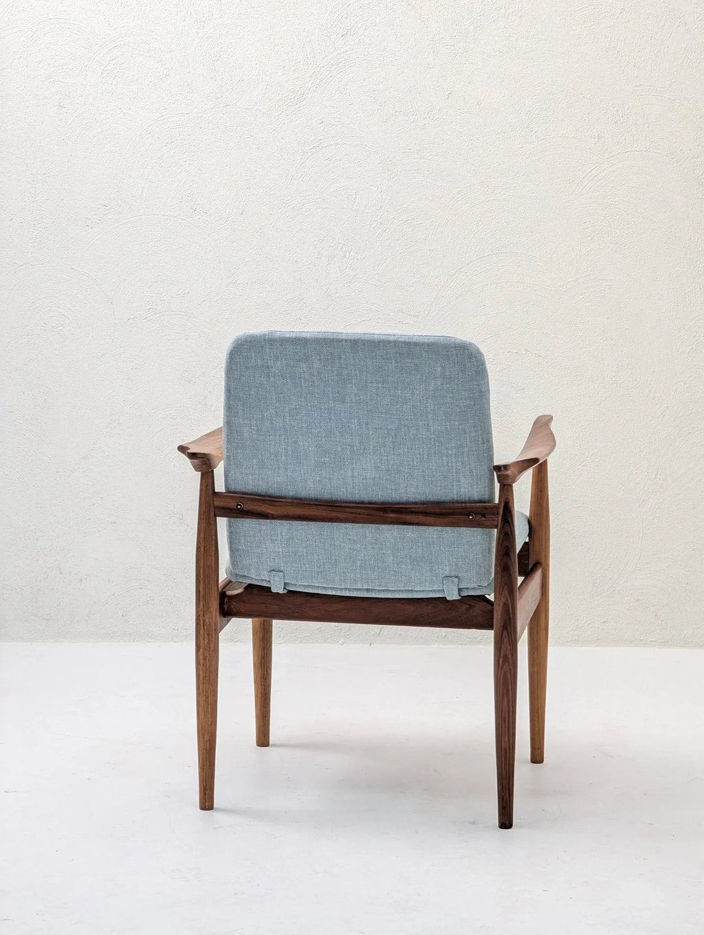 Mid-century modern sculptural armchair with teak and blackwood frame, light blue upholstery