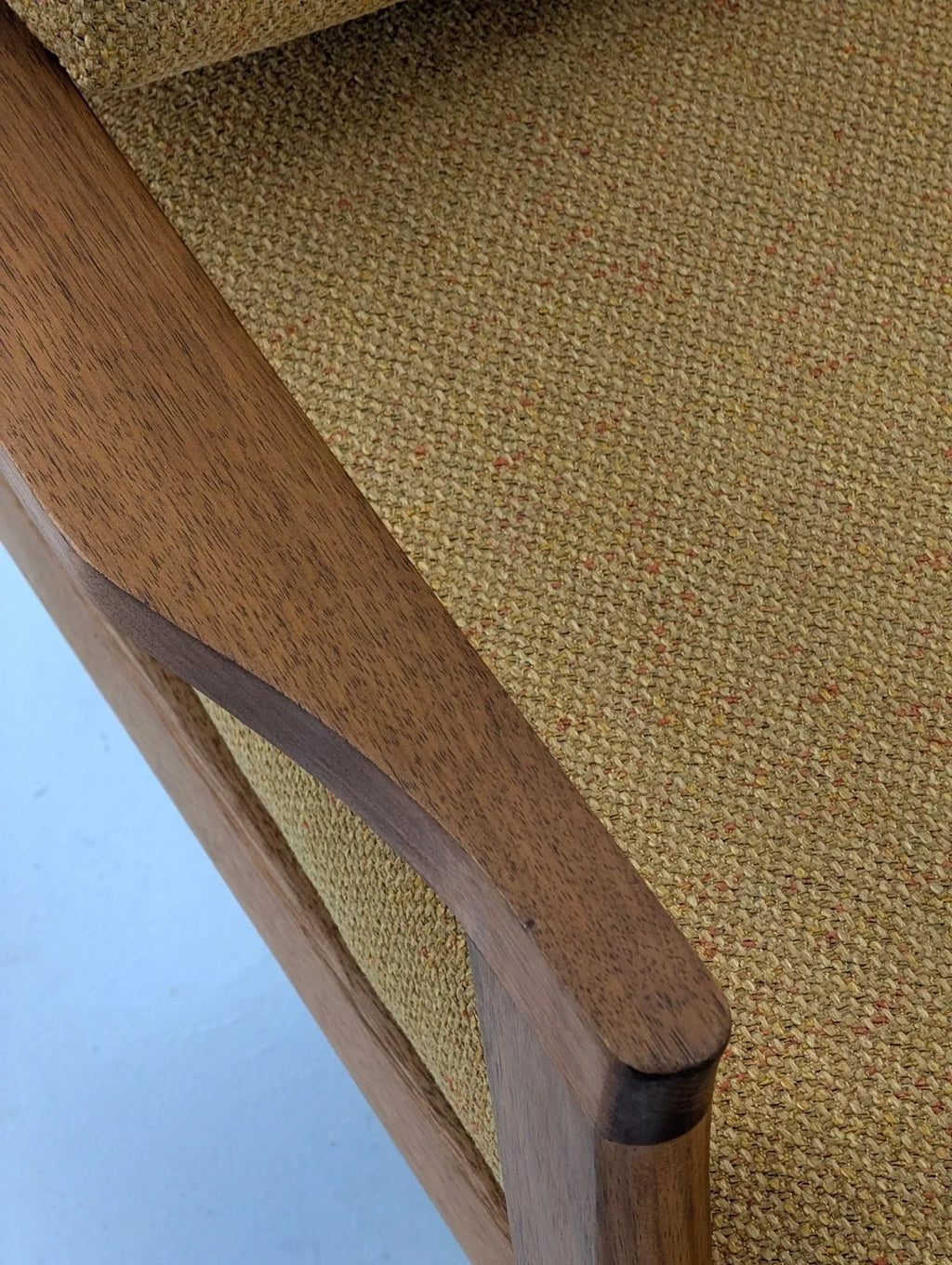 Mid-century modern solid teak lounge chair with textured beige upholstery