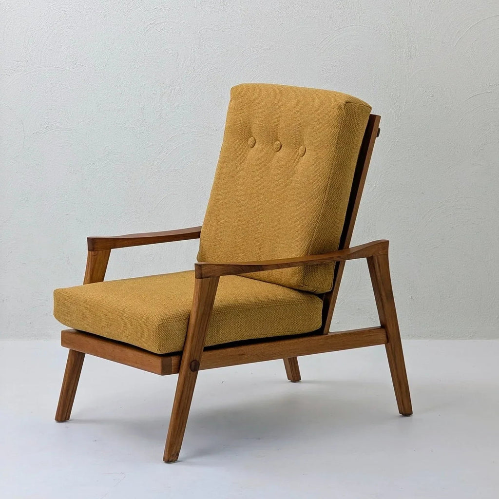 Mid-century modern solid teak lounge chair with mustard cushion on white background