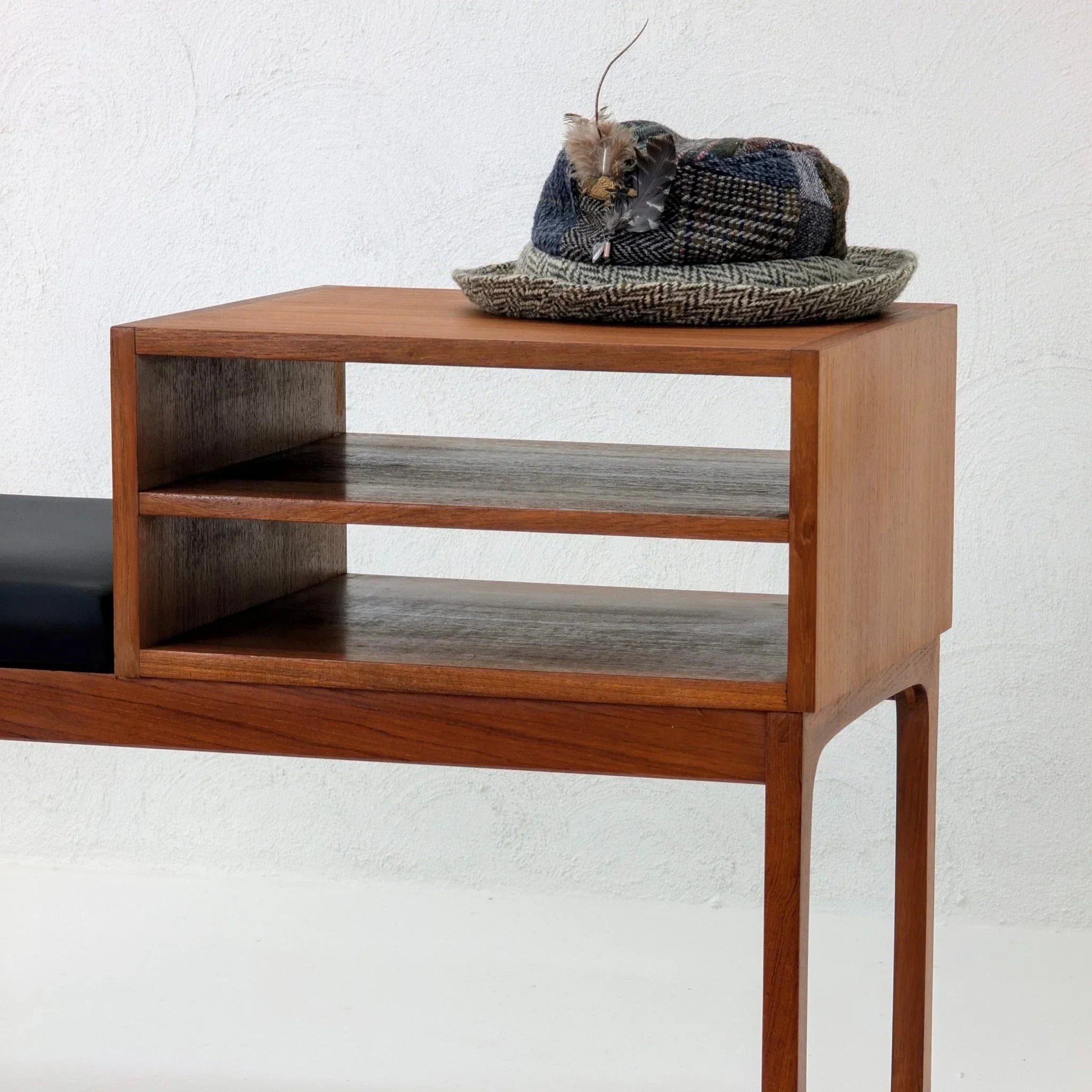 Mid-century teak telephone table with open shelves and a textured hat on top