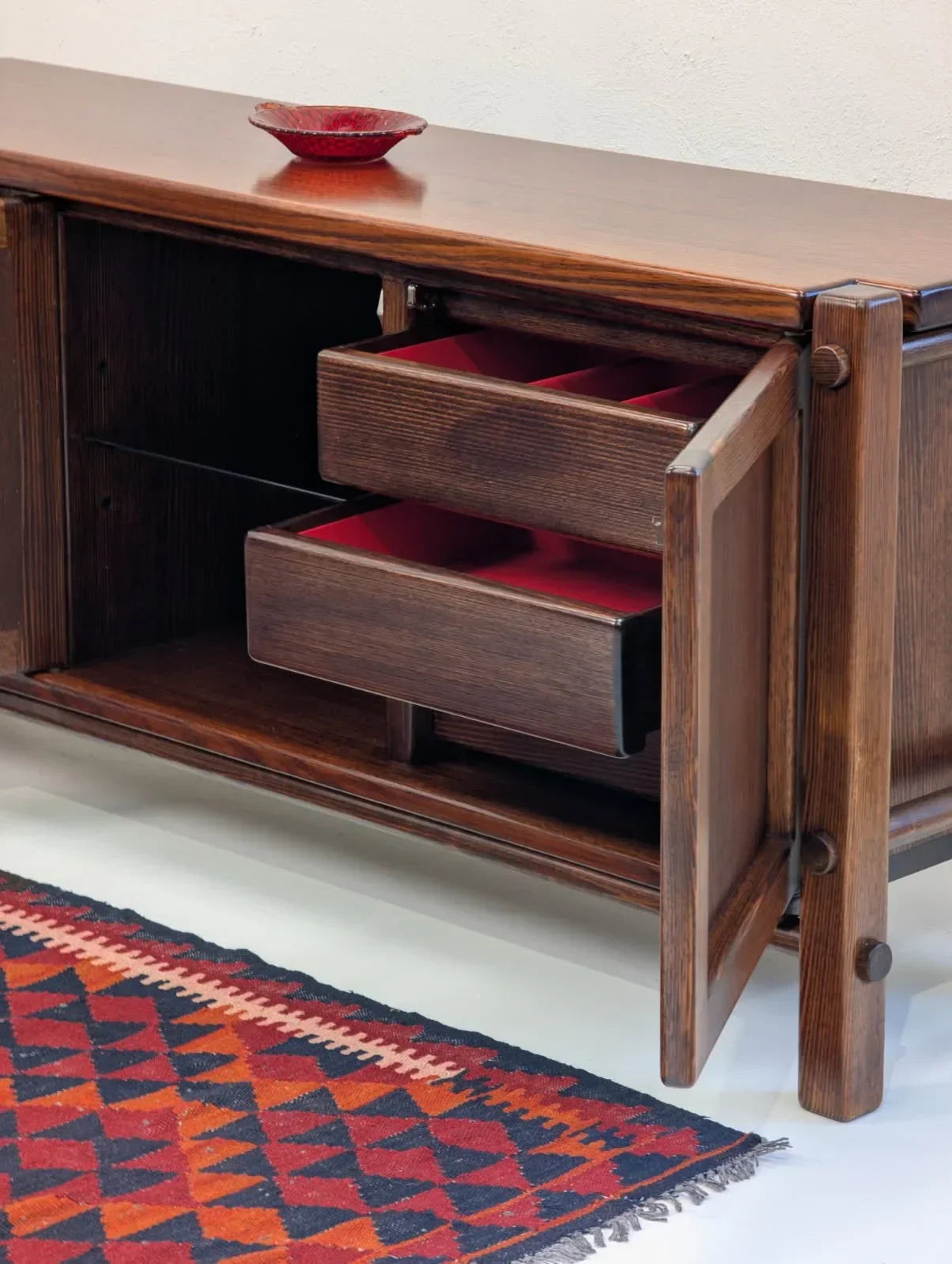 Mid-century solid Victorian Alpine ash sideboard with open drawers and red decor, patterned rug