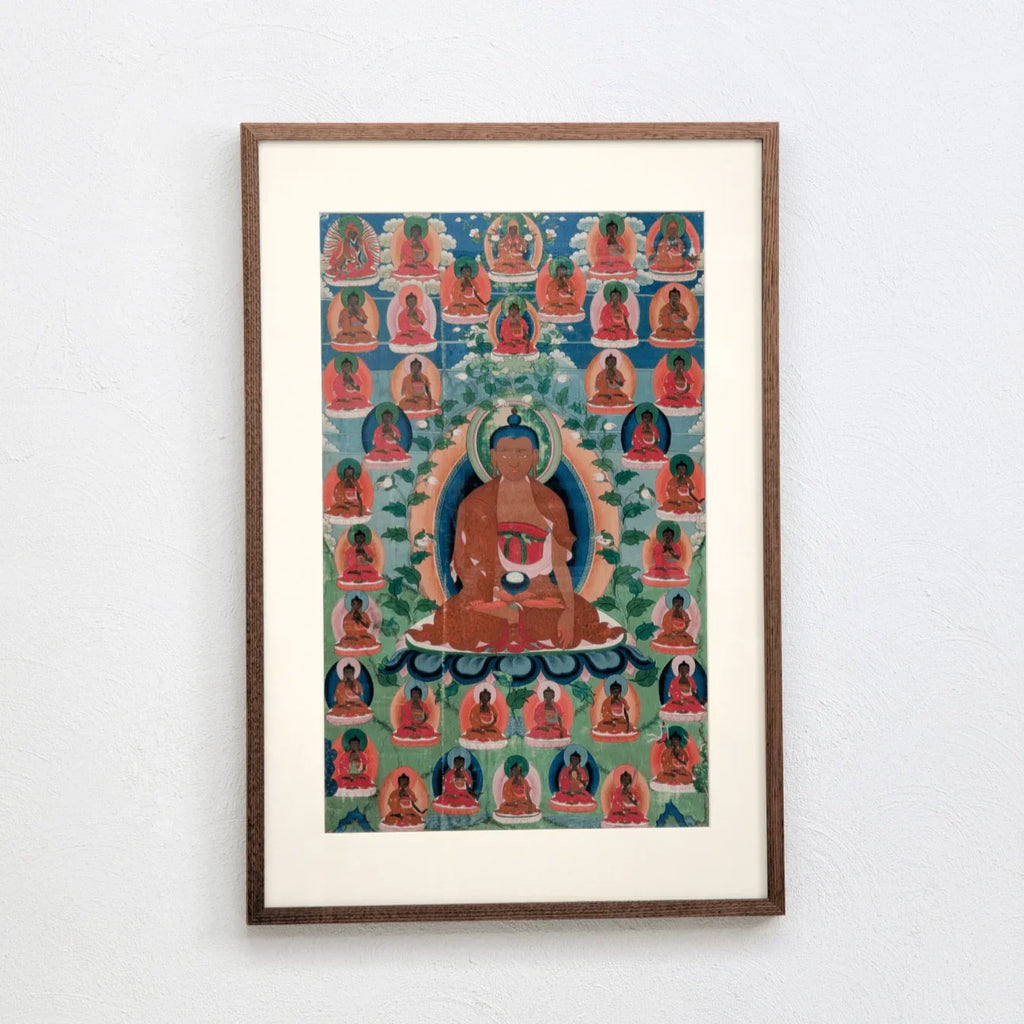 Original Buddha Shakyamuni thangka painting framed on white wall, vibrant colors, Tibetan art