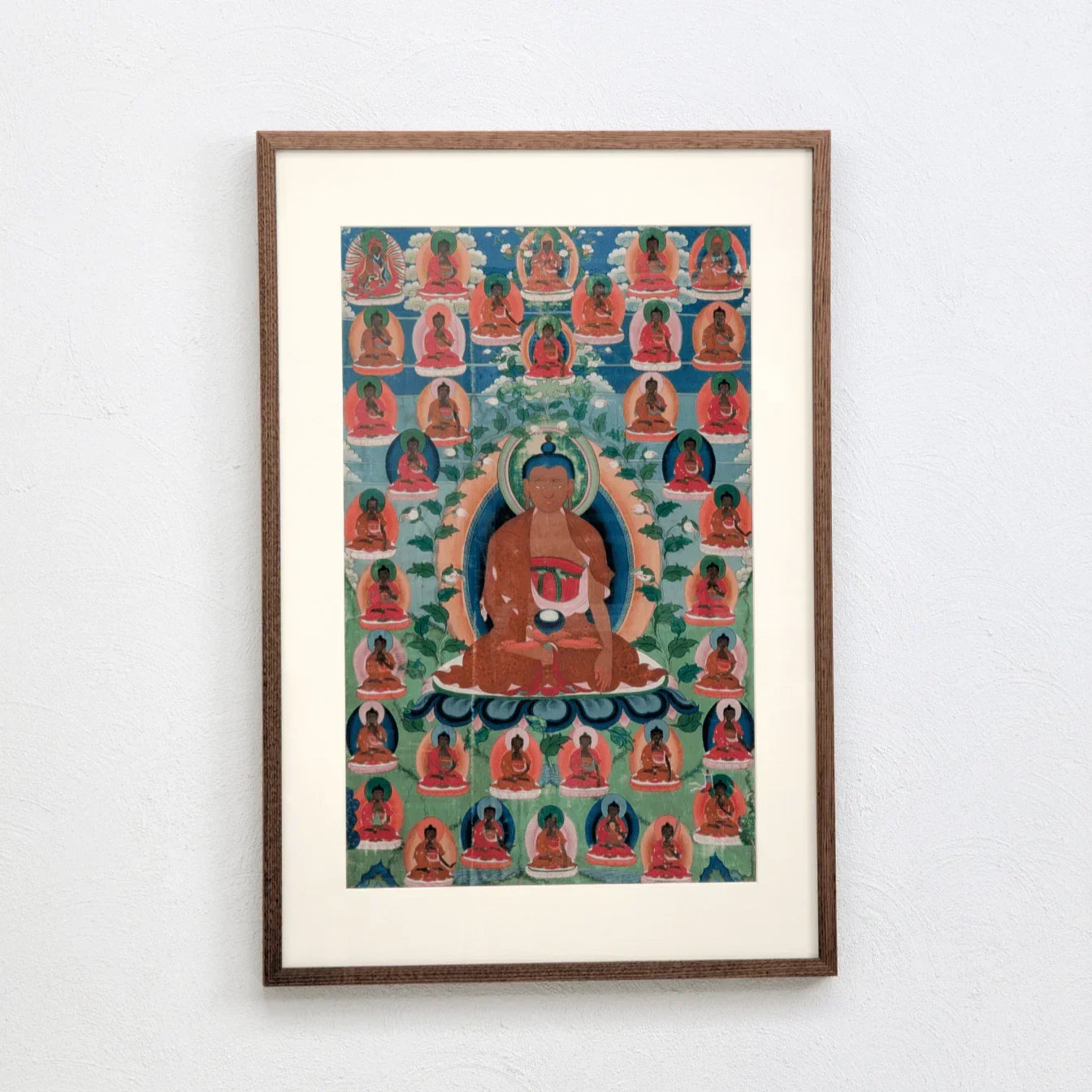 Original Buddha Shakyamuni thangka painting framed on white wall, vibrant colors, Tibetan art