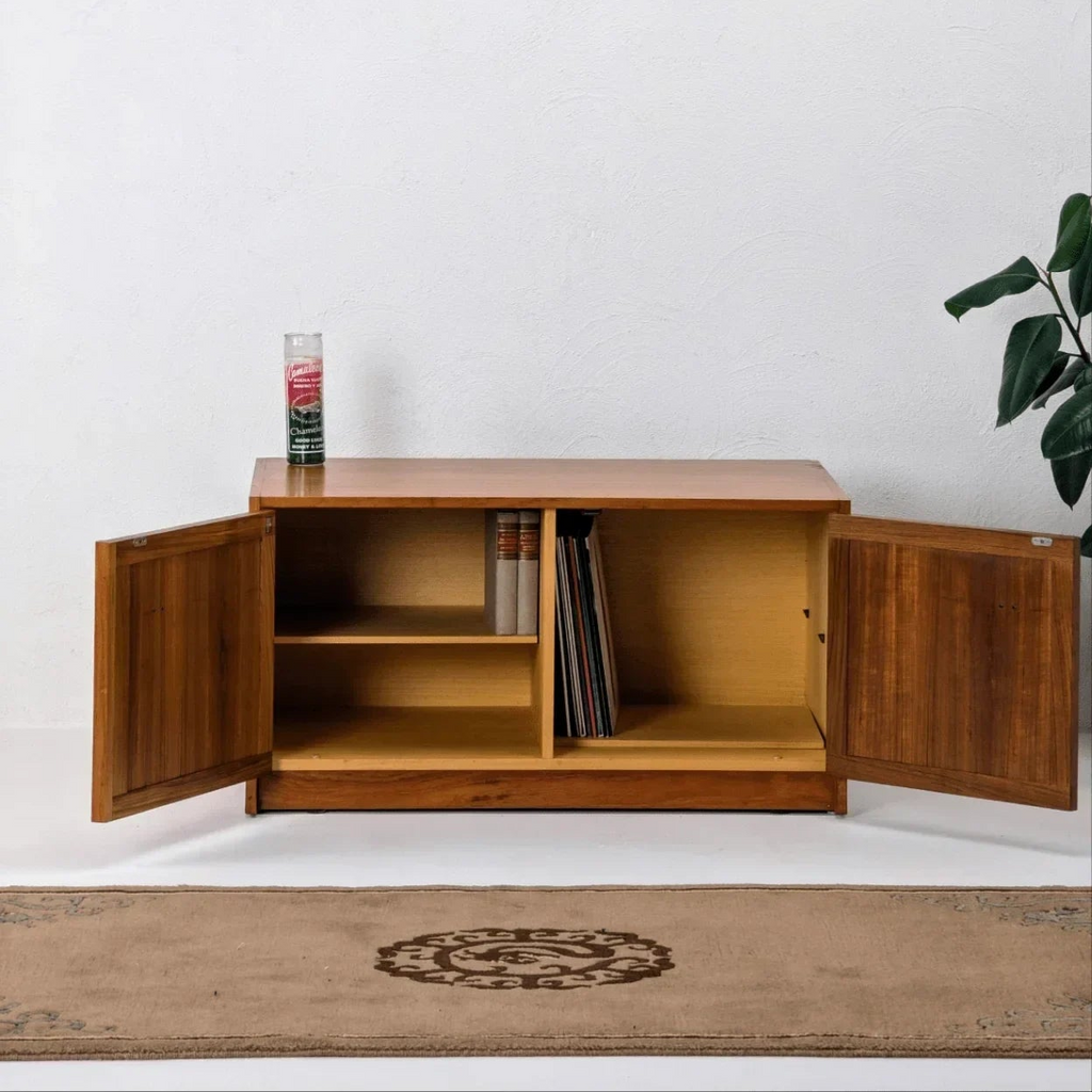 Vintage teak record cabinet by Parker with open doors, books, and vinyl records