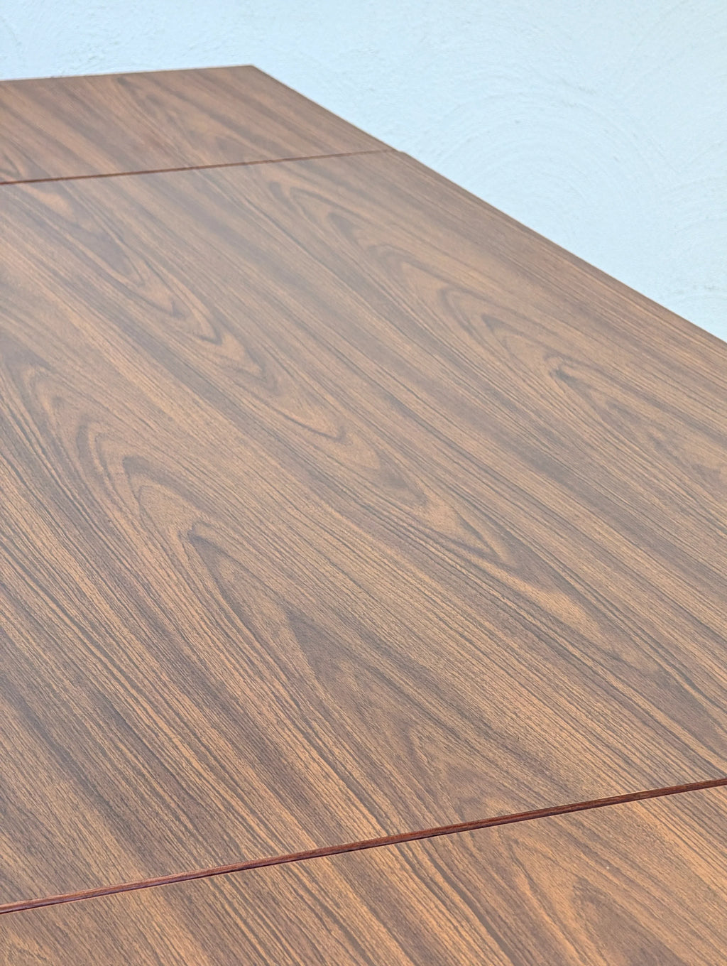 Close-up of brown wood grain surface with visible natural texture and patterns