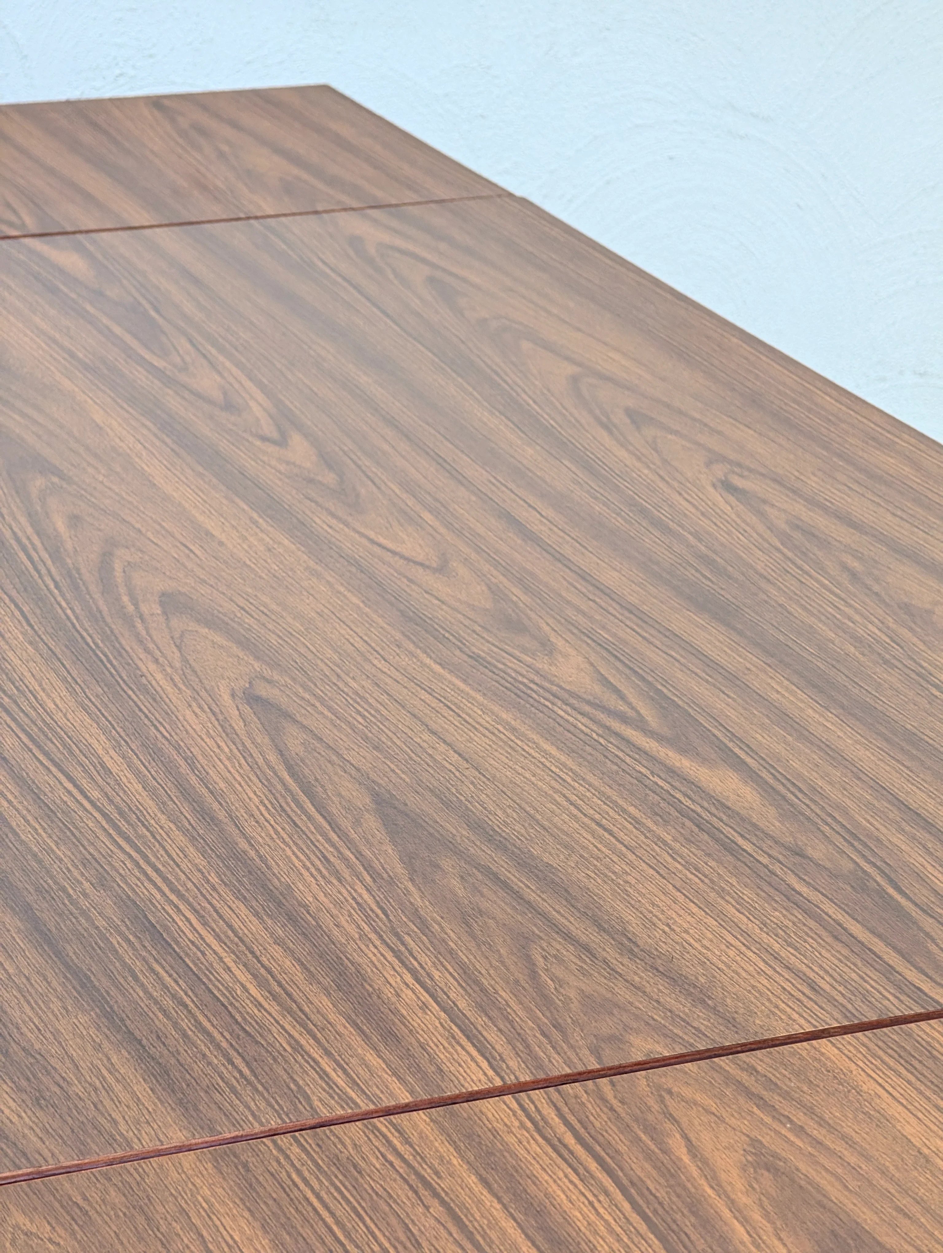 Close-up of brown wood grain surface with visible natural texture and patterns