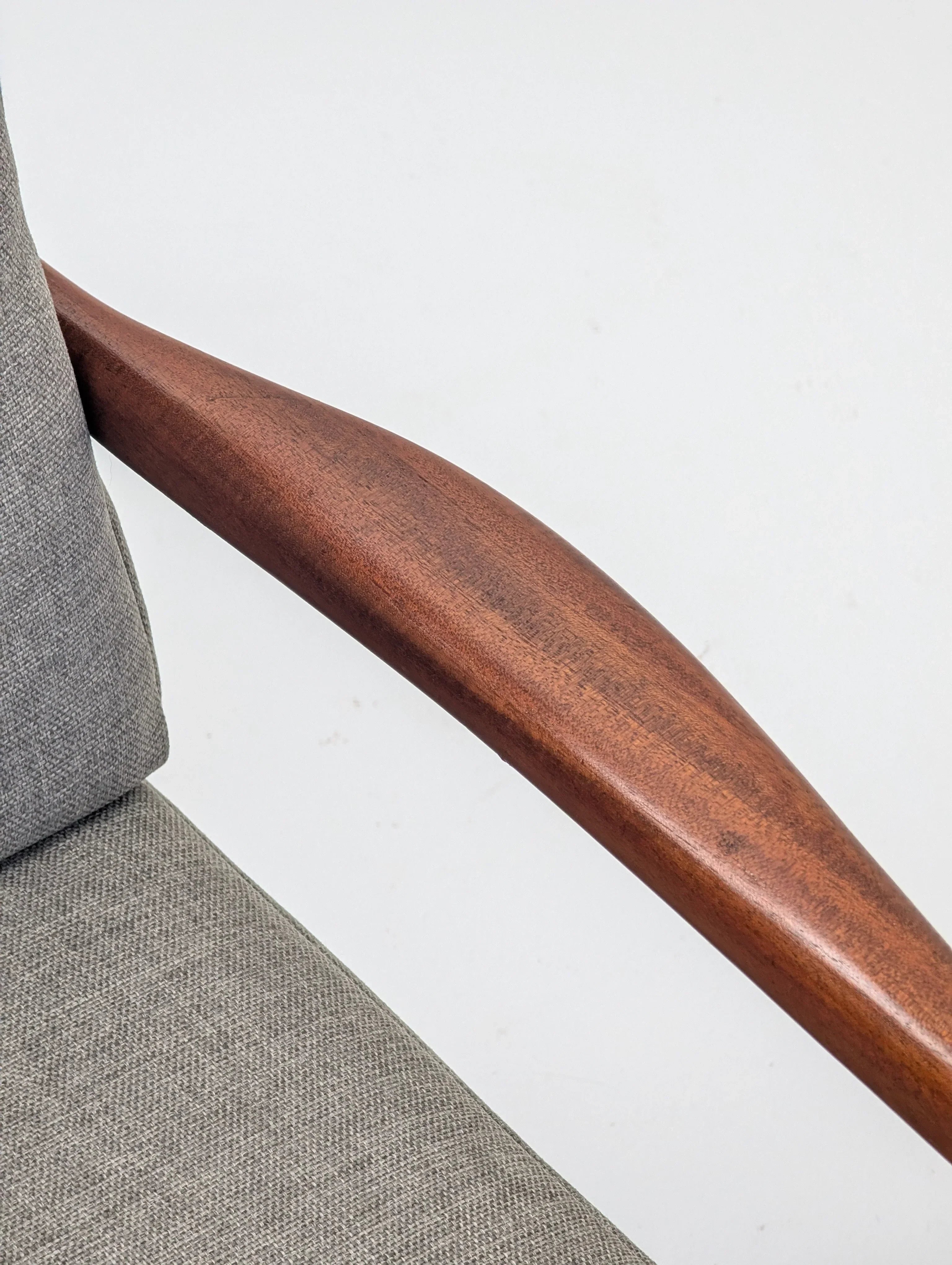 Mid-century modern chair with walnut wood armrest and grey fabric upholstery