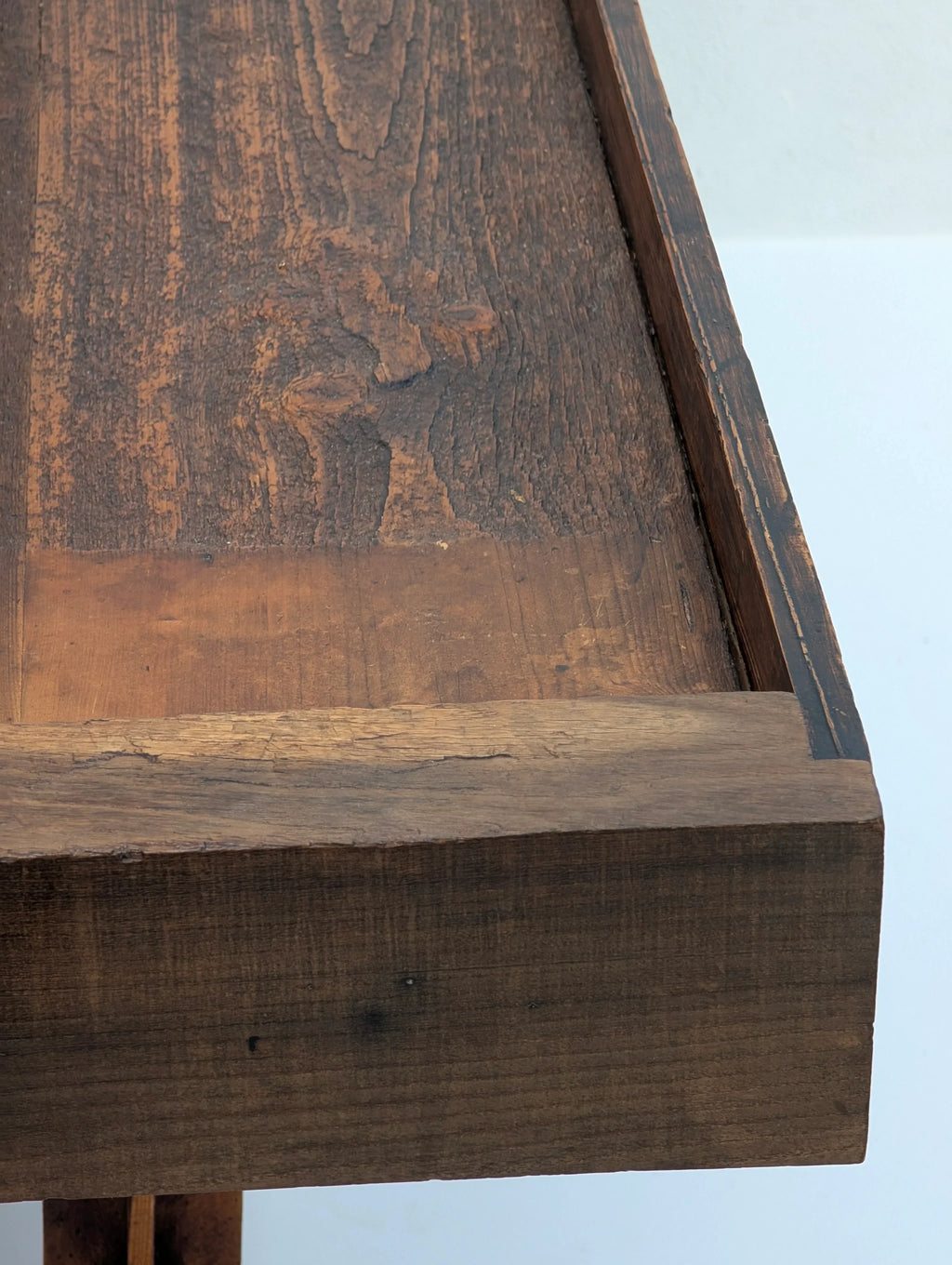 Close-up of rustic dark wood table with textured surface and natural grain details