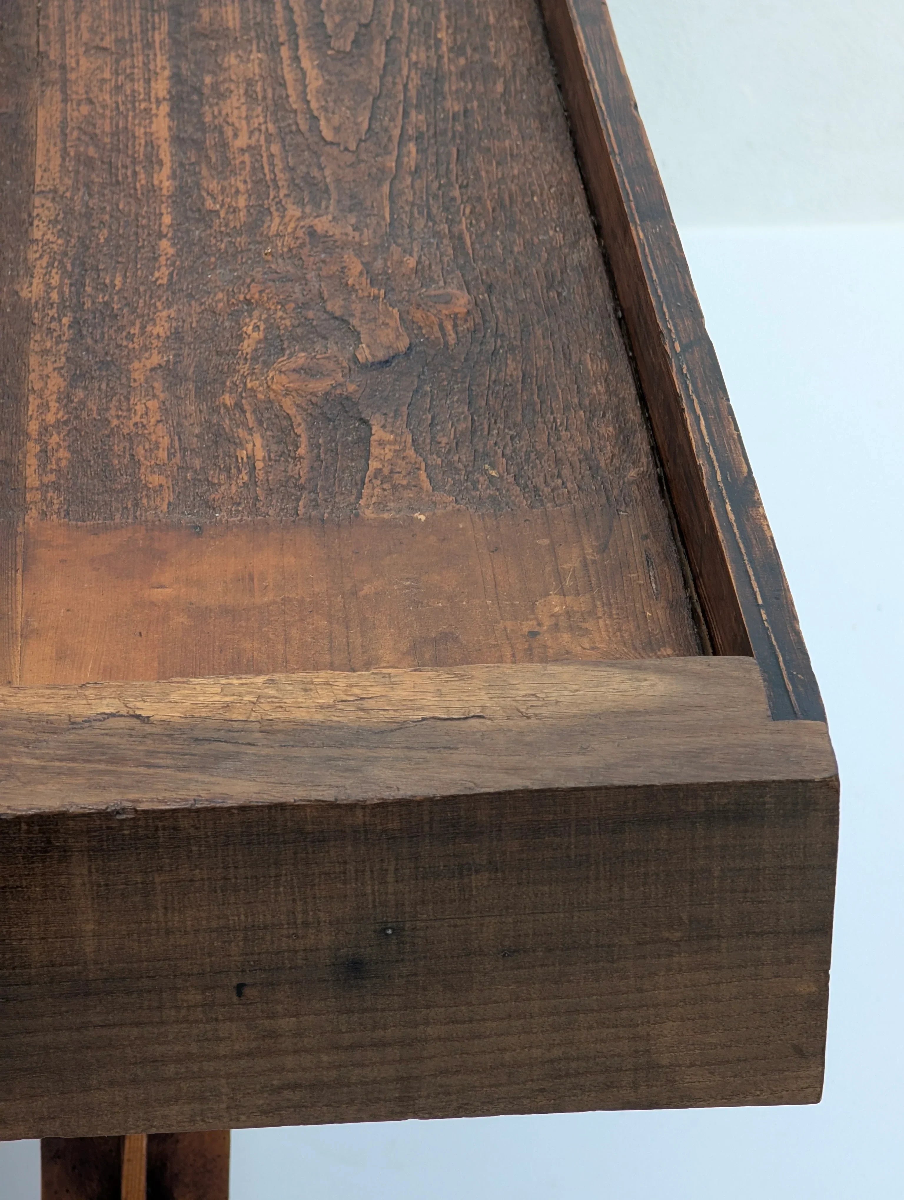 Close-up of rustic dark wood table with textured surface and natural grain details