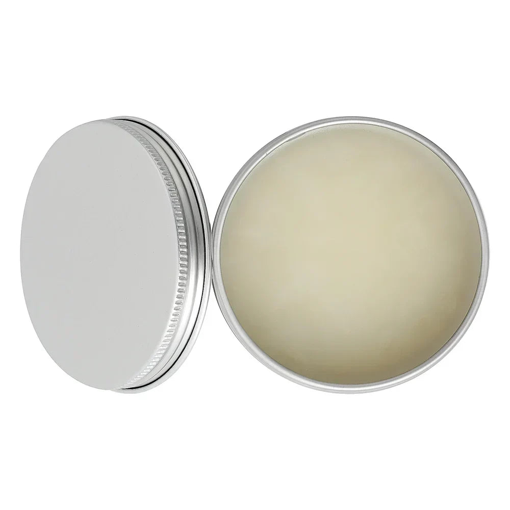 Open round metal tin with solid balm on white background, minimal skincare product