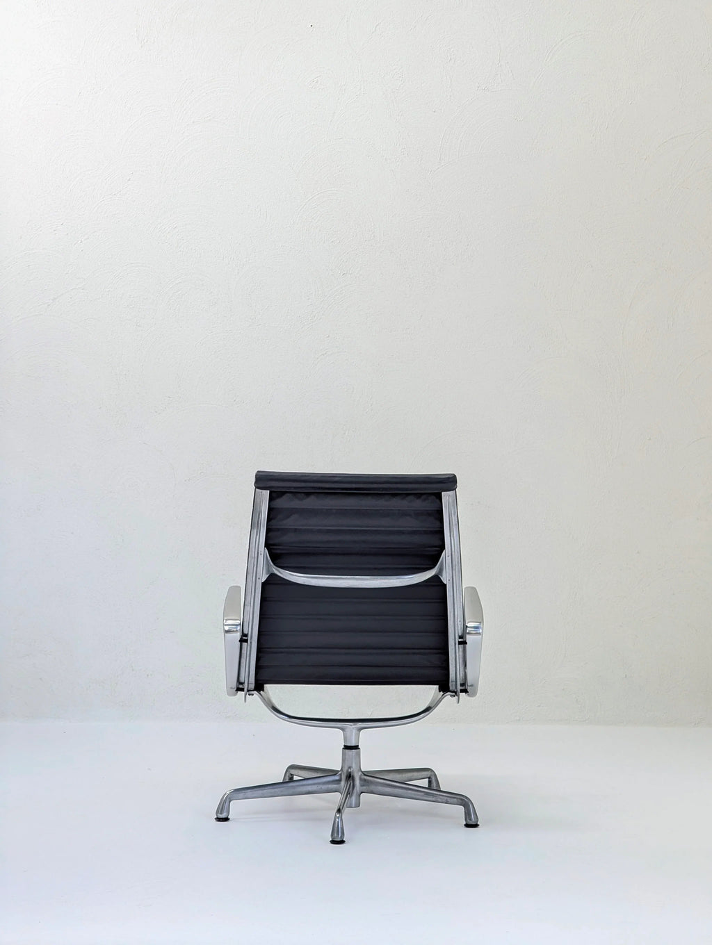Modern black office chair with metal frame on white background