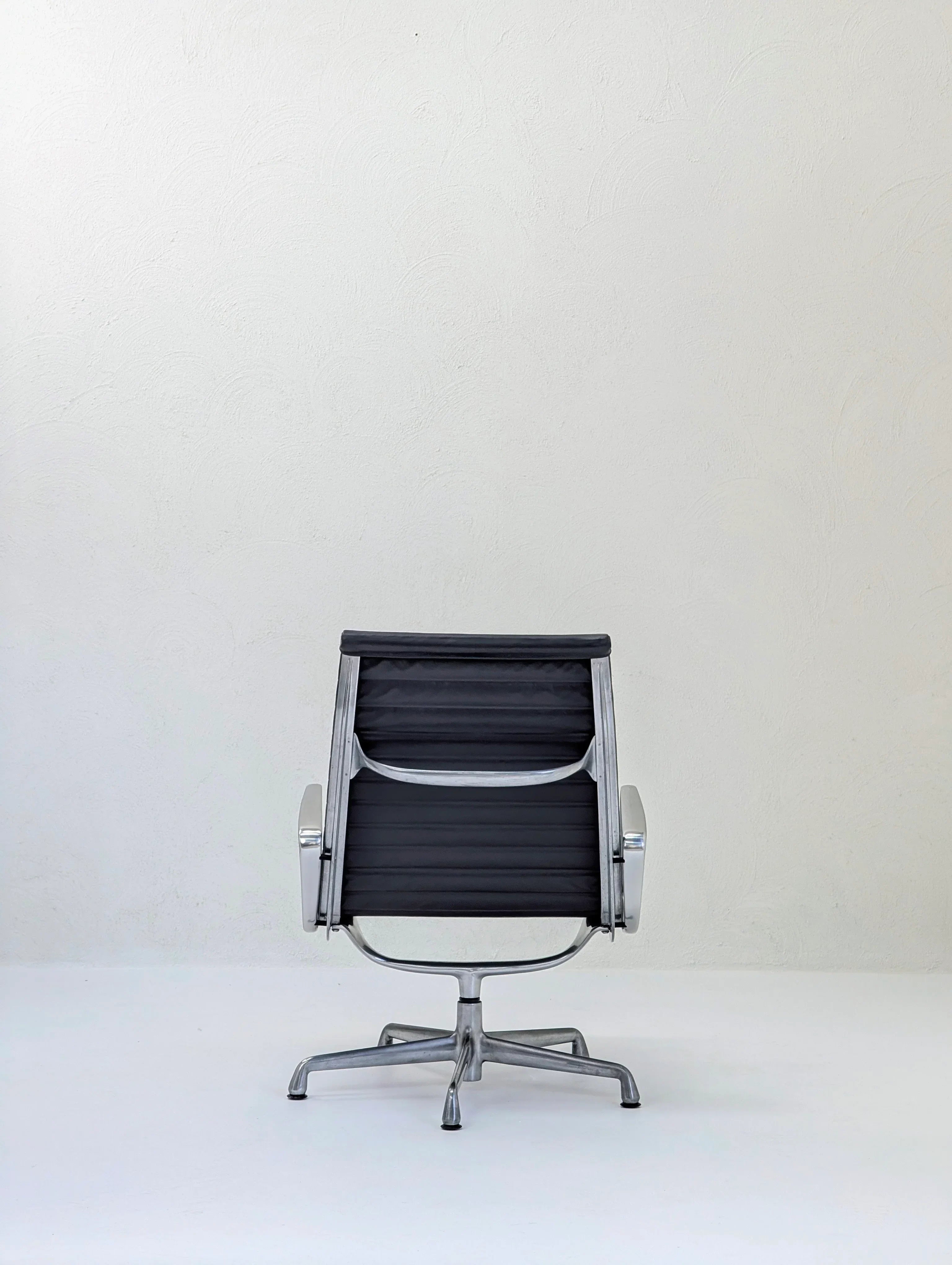 Modern black office chair with metal frame on white background