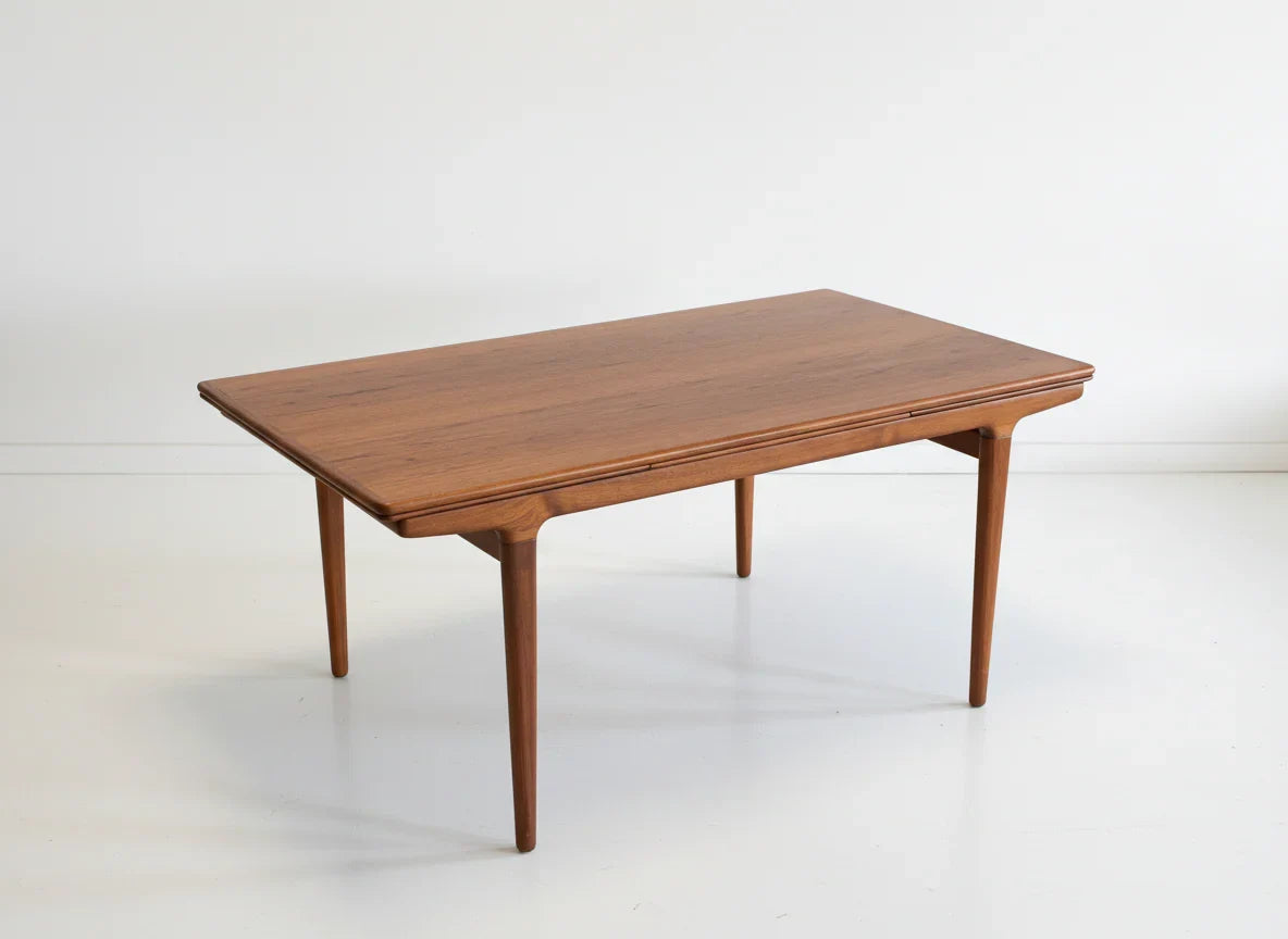Mid-century modern rectangular wooden coffee table with tapered legs on white floor