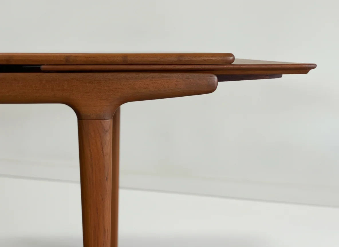 Close-up of mid-century modern wooden teak extendable dining table with clean lines