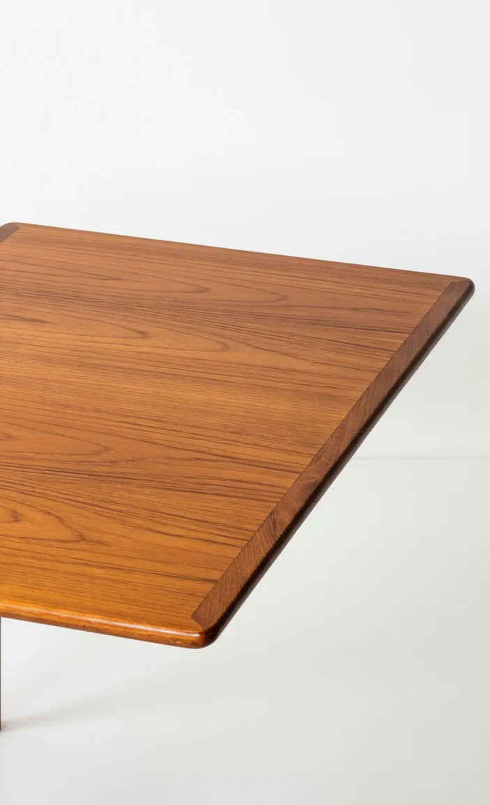 Close-up of polished rectangular wooden table top with smooth edges and natural grain